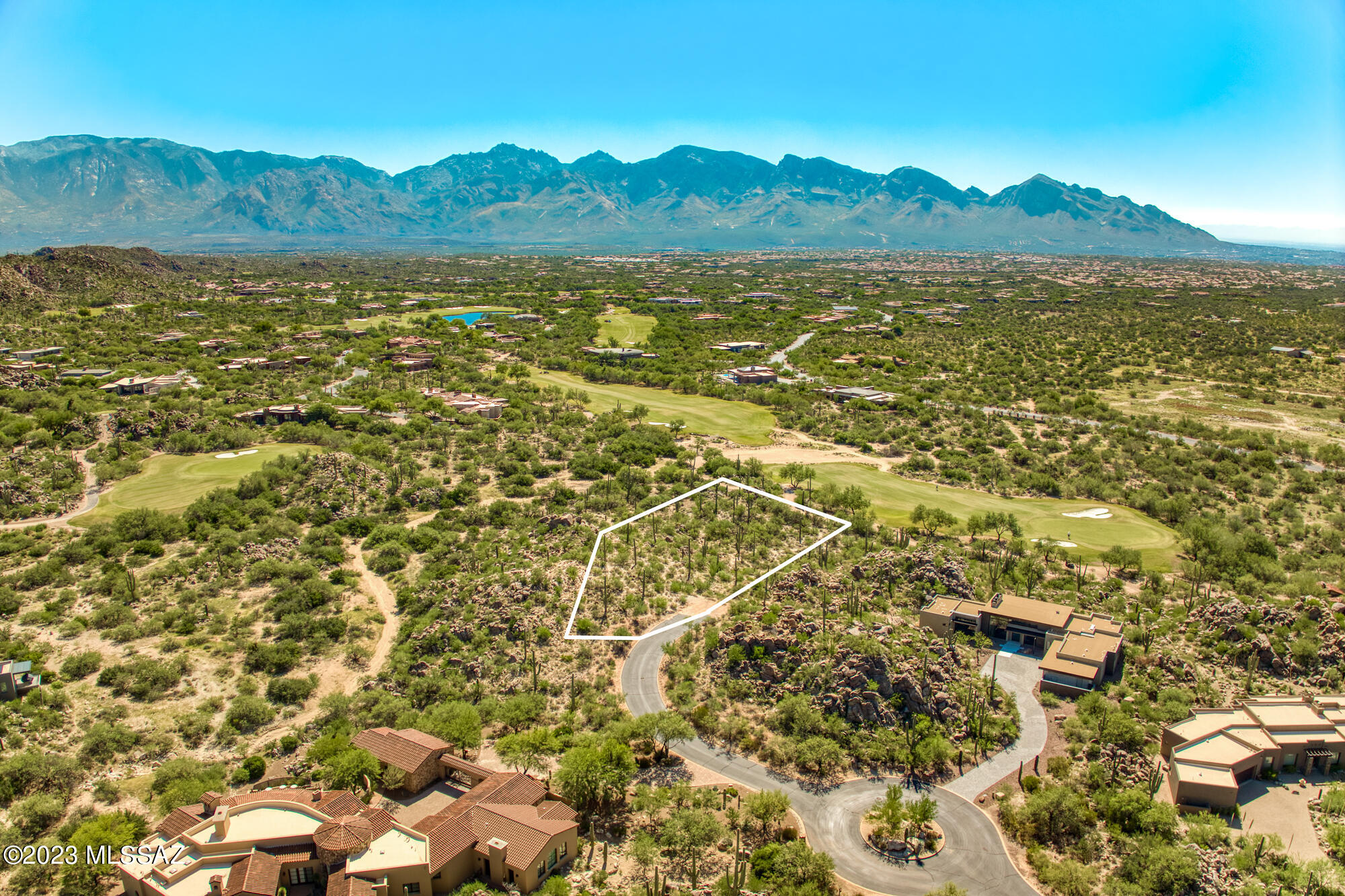 Breathtaking and private elevated hillside lot in exclusive golf community offers spectacular and unobstructed panoramic views of the Catalina Mountain range, Tucson city lights and 12th fairway of the renowned Stone Canyon Club in Oro Valley. Unusually large 2.4 acre site bordered by open space enjoys stunning desert views in addition to far sweeping valley vistas. Exceptional building site at the end of a secluded cul-de-sac is studded with saguaro and natural rock outcroppings. Last of the very best view lots overlooking Stone Canyon's championship Jay Morrish-designed course in guard-gated community with fabulous onsite Club amenities AND striking scenery! Architecturally magnificent design plans for a custom contemporary luxury home by Ron Robinette available. Club Membership Req'd!