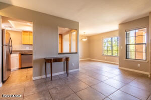 Home sweet home! Move-in ready lovely home in the foothills of Skyline Village! Enter to tile flooring, carpet in all bedrooms, ceiling fans, window blinds & a welcoming living/dining room with a cozy fireplace to keep warm during winter. Cook your favorite meals in the updated kitchen with plenty of cabinets, SS appliances & tile counters. Primary bedroom with upgraded walk-in closet & storage that will certainly give you a good night's sleep. Enjoy the incredible city views from the charming balcony overlooking La Encantada mall while sipping your sunset beverage! Includes 1 designated covered parking spot nearby. Easy walking access to top notch shopping & dining at La Encantada or a quick bike or car ride to even more. Quick access to midtown, east or west. VIEWS & LOCATION!