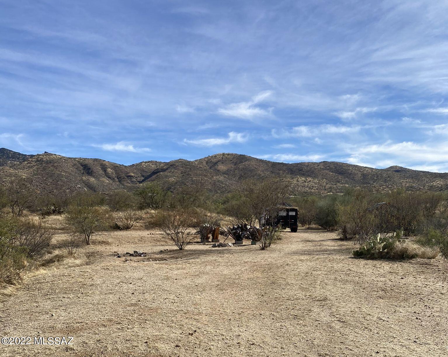 Stunning views and tranquility.  Starry nights in quiet and privacy.  This property in the Rincon Mountain foothills is surrounded by custom homes on minimum 5 acre lots. This lot includes a private well, septic, two entrances, drainage, and excavation work for a build site. Settlemeyer survey company has drawings & has staked the property in 2019. The Arizona trail is right down the road! This property is zoned for horses w/ no HOA! There are approximately 3 acres on the North side of Pistol Hill rd. and 2 acres to the South. The current excavation site is on the Northern portion.