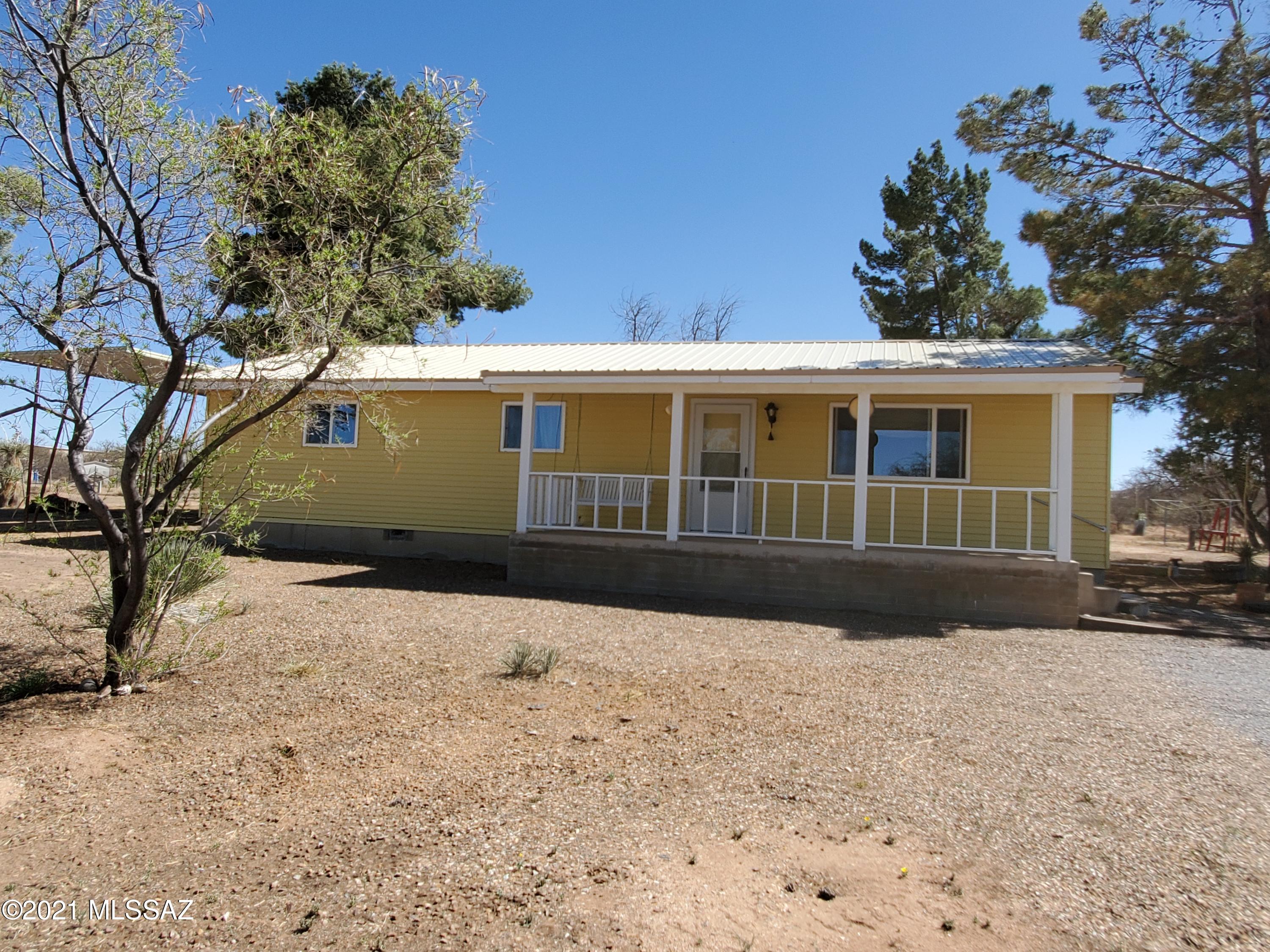 Come home to quiet, country living!  Bring the dogs & horses!  This clean, well maintained 3 bd/2 ba home is move-in ready.  Low maintenance siding.  Metal roof in 2020.  Dual pane windows.  Generous sized wall closets in bedrooms.  Dishwasher hook-up in walk in pantry.  Arizona room is heated & cooled.  Newer water heater.  Home water filtration system.  Enclosed MD style 2 stall barn w/attached pipe corrals that open to a pipe rail enclosed pasture.  Additional 1 stall metal barn w/large pasture area.  Property mostly fenced.  Beautiful Tombstone rose in front yard.  Several Huge 6' tall mature pine trees.  7 dog runs/kennels w/cement floor attached to an enclosed building w/indoor dog boxes.  Chicken coop, garden area and 2 additional storage sheds.  RV Cover.  Electric to all main outbuildings.  New electric panel.  New well pump installed in 2020.  3 car garage w/workshop area, 220 electric & cement floors.  Hay storage shed.  On a paved road w/easy access to I-10 for commuting. Don't miss out on this property.  This one won't last long!