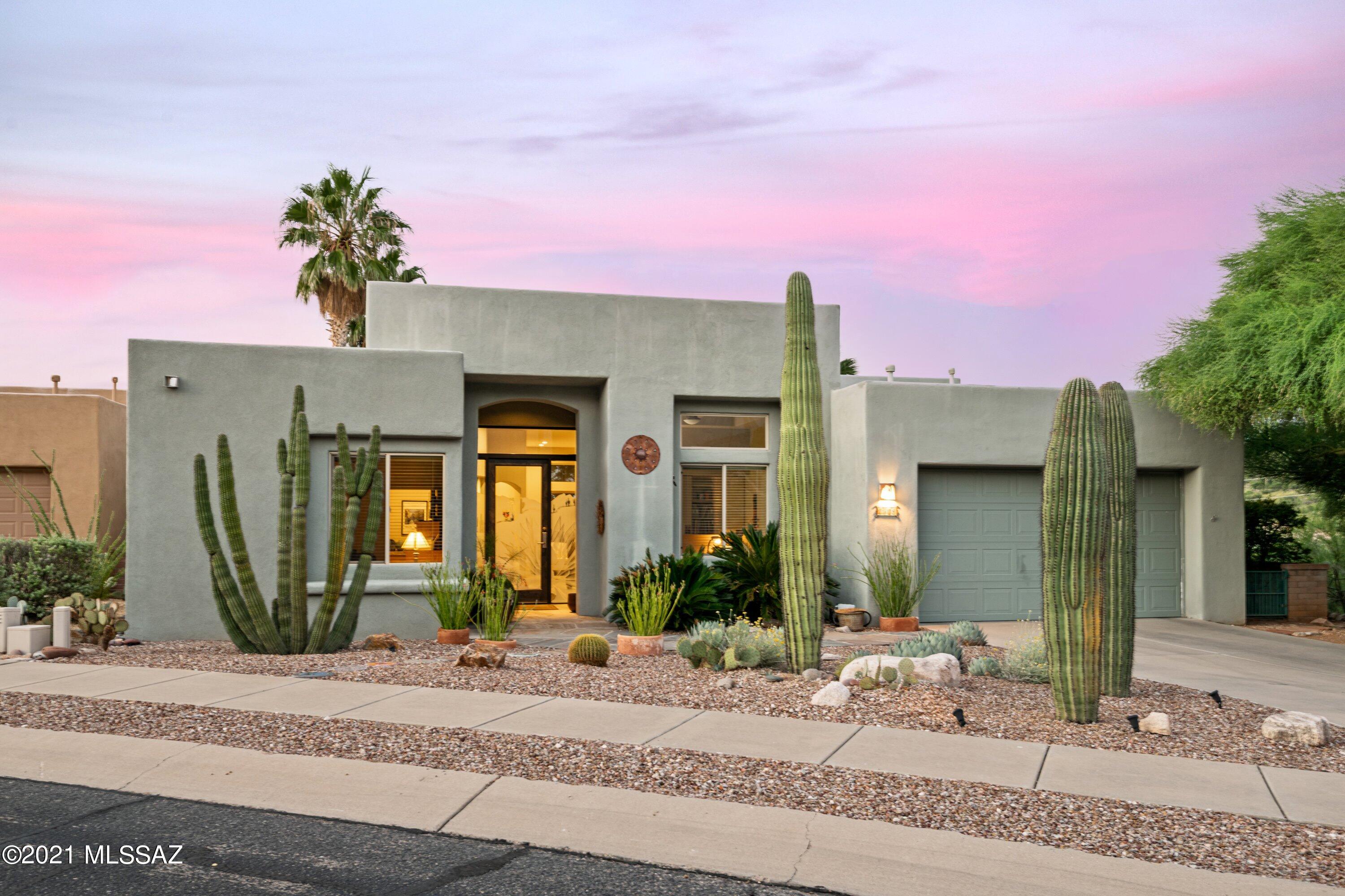 Contemporary with stunning views and a very private Gated Foothills setting. As you walk through the etched glass custom front door it leads you into a very open floor plan, including 2 lighted art niches and 12 foot ceilings. This is a corner lot affording open views to the south, west, and north. Immaculate home has floor to ceiling windows, porcelain tile throughout, great room fireplace & built-ins overlooking the covered patio & city lights. The exterior is professionally landscaped with covered flagstone patio & Koi pond with water fall. Kitchen has all stainless steel Frigidaire Professional Series appliances & a custom built appliance cabinet w/storage drawers. The backsplash behind the stove is a signed custom mosaic designed & installed by the original owner. Laundry room has newer washer & dryer and overhead storage cabinets. Master bathroom was recently updated with new tile countertops, vessel sinks and faucets. Guest bathroom is fully tiled & has solar tube for additional lighting. Ceiling lights were recently replaced with LED. The large great room, kitchen & master bedroom windows were replaced in 2020 with Amerimax Energy Star rated double pane AG34 argon windows.