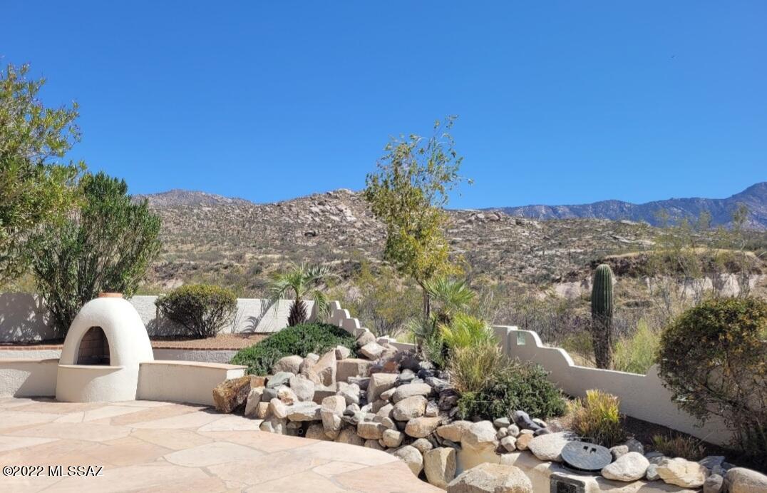 This 3,010 sq. ft., highly upgraded and expanded Dakota model, home is uniquely situated on
a premium lot on a quiet cul-de-sac with unobstructed , panoramic mountain views from inside and out and has direct access to hiking trails from the property.The open and spacious floor plan of this home offers many options for furniture placement and the split bedroom floor plan give guests plenty of privacy including a private entrance. The energy efficient kitchen has upgraded stainless steel appliances with built in oven, range and microwave, granite countertops and honey maple cabinetry with pull out shelving and wall to wall pantry. The media room comes fully equipped with all components including surround sound system. Custom lighting and built-ins, jetted garden tub, central vac, air filtration and security system, R38 insulation and 2x6 construction. The very private yard with mature landscaping and fruit trees offers expansive mountain and desert views from three separate flagstone patios with beehive fireplace, pergola with remote louvers, large unique sunshade and gas hook-up. Extended two car garage with built-in storage and access to secure dog run. New air conditioner's, furnace, irrigation system and freshly painted exterior and interior with
neutral color palette makes this beautiful home move in ready!