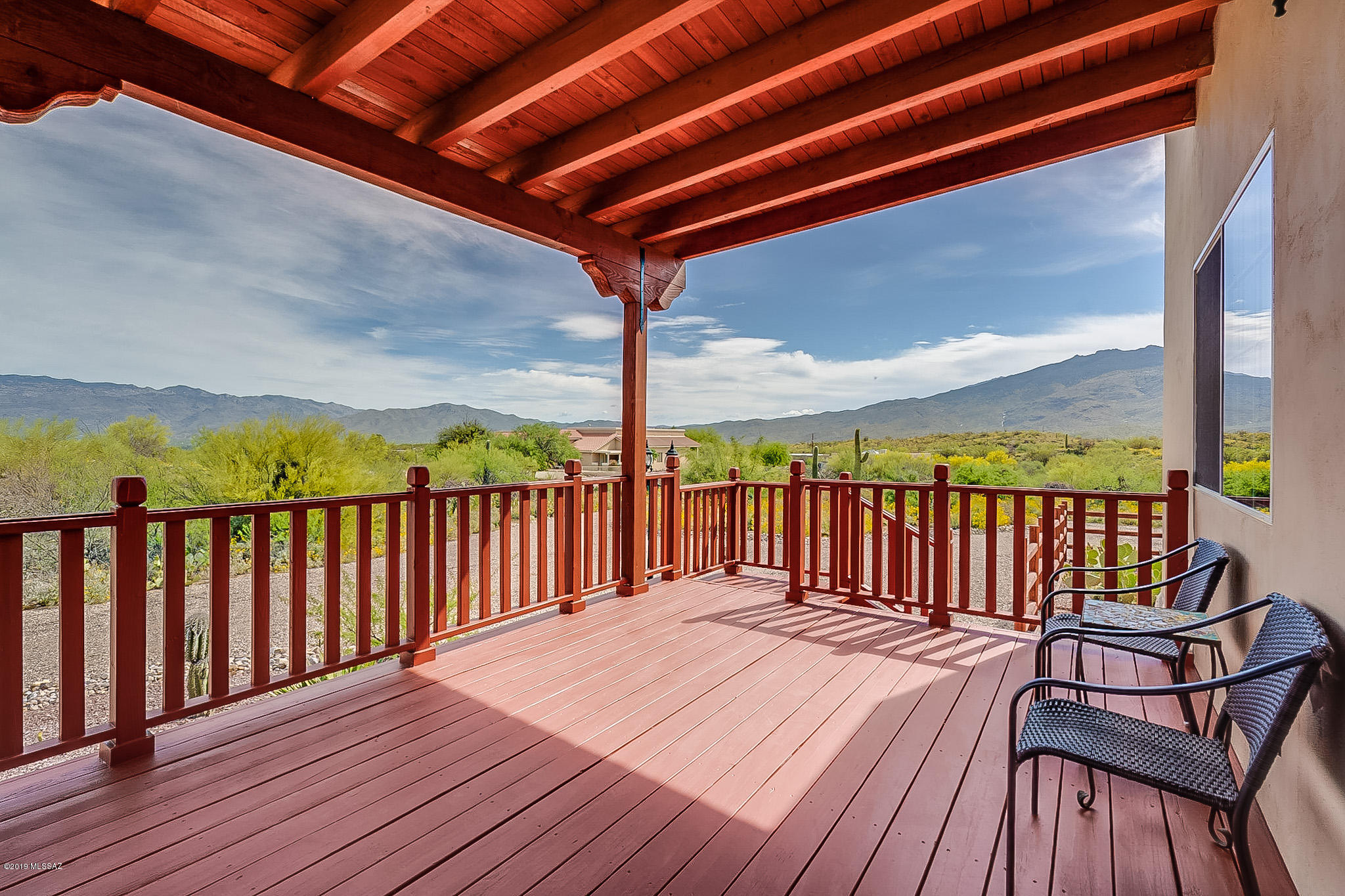 Custom built home with EVERY THOUGHT TO DETAIL, starting with the HAND CARVED, SOLID WOOD FRONT DOOR to the HIGH CEILINGS W/EXPOSED WOOD BEAMS AND HERRINGBONE WOOD INLAY. Large North facing patio includes SWEEPING VIEWS OF CATALINA AND RINCON MTNS, Large East Patio looks out to PRIVATE OASIS W/GRASS, FLOWERS, CACTUS GARDEN AND MATURE TREES w/Rincon Mtn views. Kitchen HAS GRANITE TILE COUNTERS, SS APPLIANCES AND HAND CARVED, SOLID WOOD CABINETS DEPICTING DESERT SCENERY.  Master Bed w/large walk-in closet, huge bath w/walk in shower, Jacuzzi tub, double sinks and MORE VIEWS. Horse property includes large barn w/loft, currently used as workshop. Foam in roof for added insulation.  Don't let the Golf Link address fool you, it is on a private road.