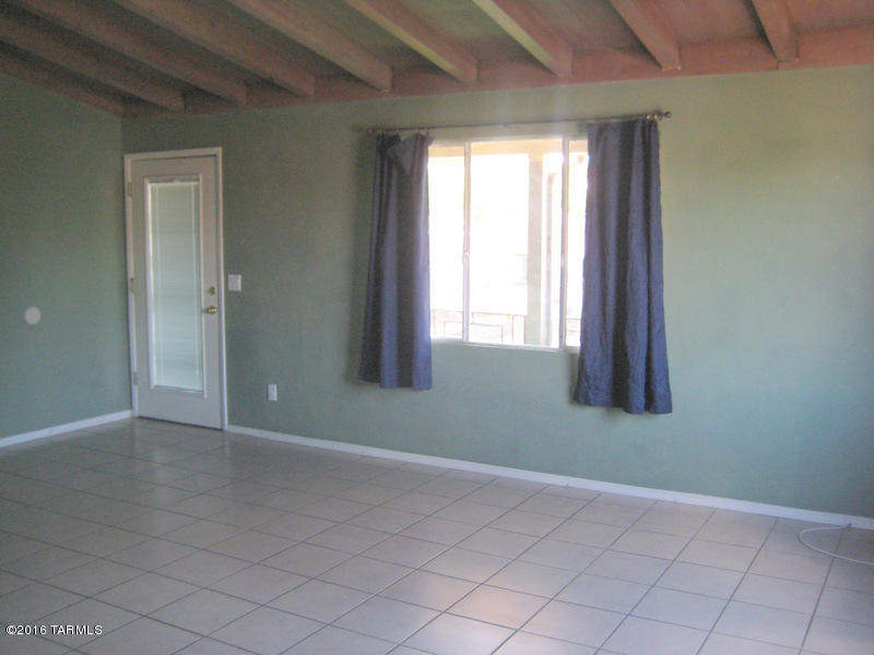 Clean 2 bedroom/ 2 bathroom upstairs unit off 5th Street. Open beamed ceiling in living room, ceramic tile throughout entire property. Large bedrooms with ample closet space. Kitchen features white appliances to include refrigerator, dishwasher, ceramic cooktop, oven, built-in microwave & disposal. Community laundry and one-car carport with carport storage. Sunset and mountain views. Close to shopping, transportation and a couple miles from U of A. Unit includes water/sewer/trash.