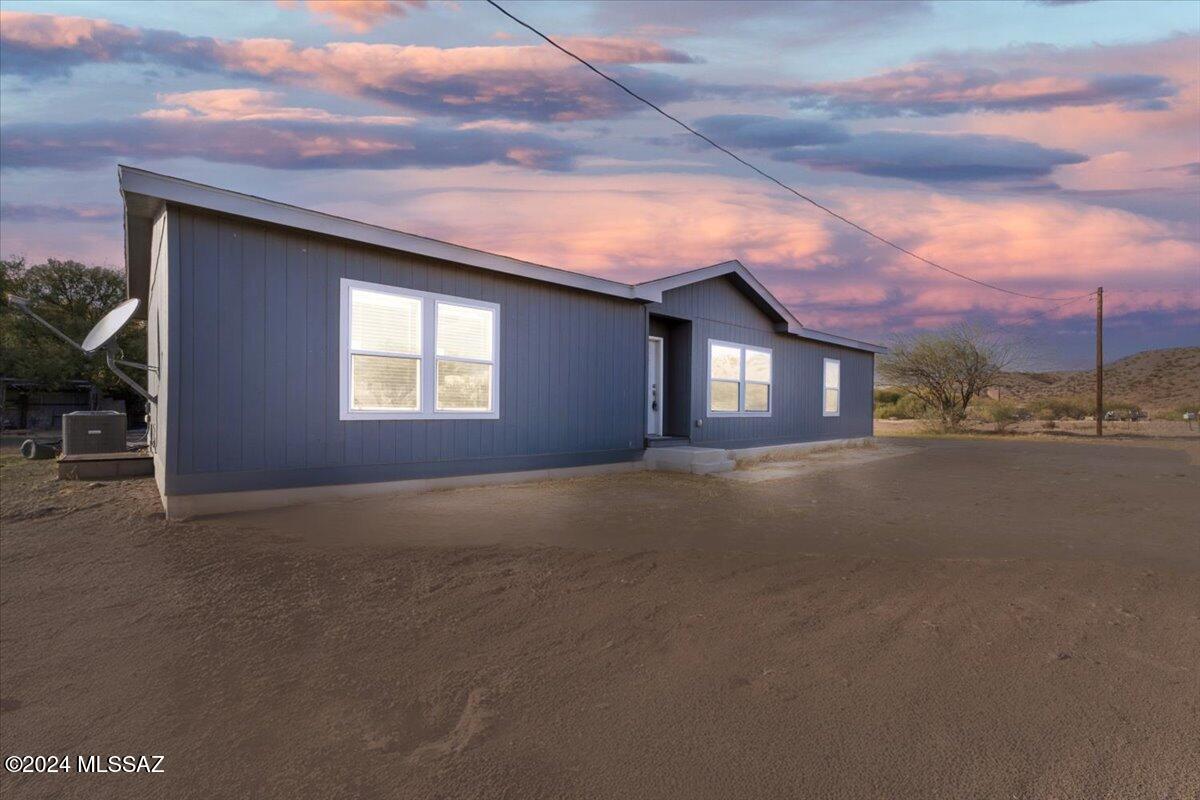 Dreamy Country Living with Endless Possibilities! Nestled on 2 acres, this 3-bedroom, 2-bath manufactured home is the perfect blend of comfort and rural charm. Designed with both functionality and leisure in mind, this property is a haven for nature lovers, horse enthusiasts, and anyone seeking a peaceful lifestyle. Walk into the open-concept layout that features a bright living area, a functional kitchen with ample storage, and a cozy dining space. Enjoy your  private master suite with en-suite bath featuring soaking tub and separate shower. 2 additional bedrooms perfect for family, guests, or a home office with a 2nd bathroom. Horse-ready property fully equipped to accommodate your equine friends, with room for stables, a corral, or a riding arena. Call for a showing today! The property is on a shared well. There are water hook ups throughout the property to make watering gardens or animals easy. The expansive land offers plenty of space for gardening, outdoor entertaining, or even future expansions like a workshop. Whether you're starting a homestead, raising animals, or simply enjoying the peace and quiet, this property is a rare find. With room to grow and customize to your heart's content, it's more than a home it's a lifestyle.