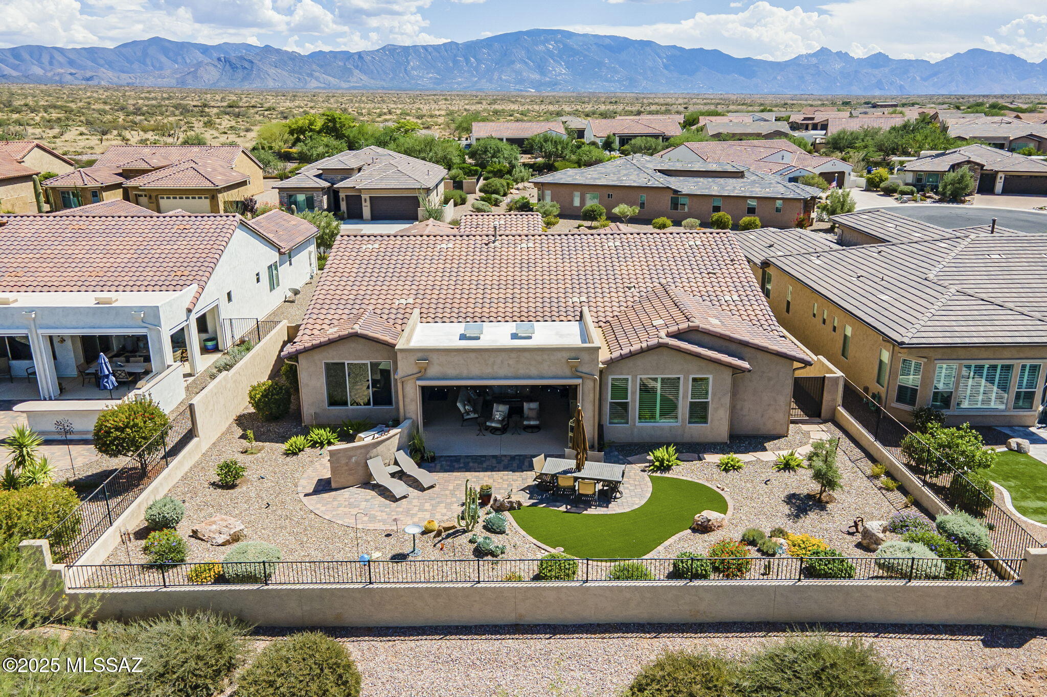 Tesoro floor plan w/casita in SaddleBrooke Ranch, active adult community with world-class amenities. Built in 2018, this 2,904 SF home backs to the Tortolita Mountains w/golf course views in the distance. Featuring 3 bedroom suites, large den, & powder room, designed for comfort and entertaining. Chef's kitchen boasts quartz, SS appliances, gas cooktop, dual ovens, built-in fridge, butler's pantry, walk-in pantry, and large island. Great room offers a custom entertainment center and bar w/wine fridge. Primary suite includes dual vanity, glass shower with bench, and spacious walk-in closet. Casita has cabinets, wine fridge, sink for guests. Extended garage, laundry with storage, zoned HVAC, and expansive patio with retractable screens, BBQ, turf, and pavers complete this stunning retreat.