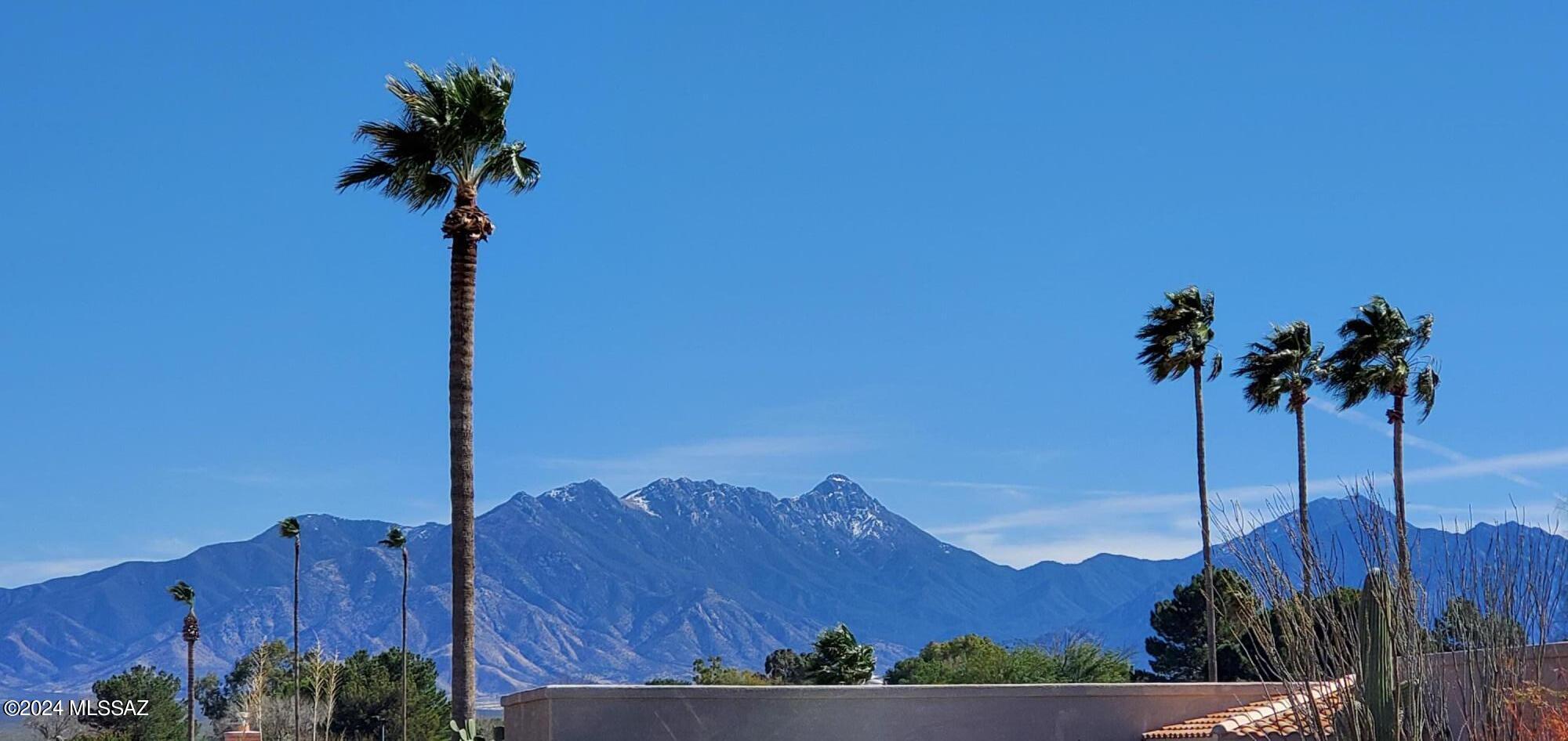 Enjoy Santa Rita Mtn views from the Front Courtyard of this 1,960 sq ft custom built home situated on 0.24-acre lot across from 130-acre golf course. 1-level open concept living & dining w/ 9' custom wood ceilings & Fireside living! Eat in kitchen features grilling area + electric cooktop + range/oven w/convection microwave above, Refrigerator new in 2020, Dishwasher new in 2023, Pantry & storage, Ample Countertops & Cabinets w/pull outs. Den/Hm office. Mtn Views from the Primary bedroom suite w/Walk-in shower & dual vanity in bath. Murphy bed in guestroom. Jack & Jill bathroom. Stacked W/D in laundry. Saltillo tile, carpet in bedrooms. Added Ramada's & bk patio spaces. Workbench & storage in the 2-car attached garage. Numerous imrovements. Close to Country Club of GV + GVR facilities + Country Club of GV has a driving range, chipping & pitching areas, sand trap & 2 putting greens, lessons from PGA professionals, Pro Shop & golf cart storage + 13 GVR facilities await! Central location w/Restaurants, Farmers Market & shopping nearby.