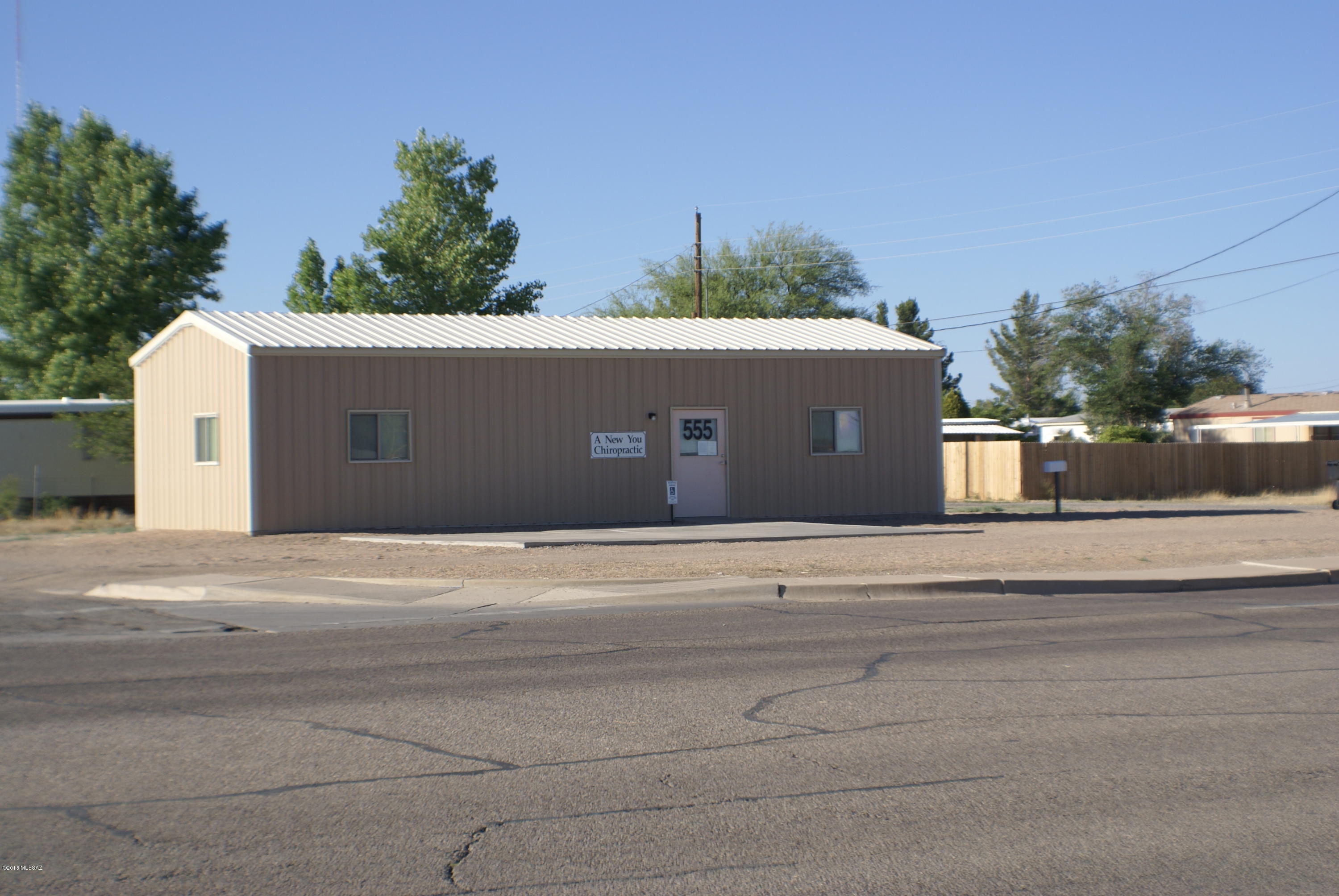 Turn Key Professional Office Location. 1018 sq. ft Metal Office Building measuring 50' x 20' built in 2006. Property has approximately 81' of W Rex Allen Dr frontage.  Currently used as a Chiropractic office.  Has 2 separate office spaces that are approximately 15'x 18' each.  Shared waiting room and ADA compliant Bathroom.  Could be reconfigured to suit your needs. Completely finished inside, equipped with Central Heating and Cooling.  Property is Zoned R-4 (Semi-Commercial)
Lot has 3 paved / concrete parking spaces (1 is handicapped).  Lot is all gravel and has plenty of additional parking.  

Owner Financing is available- terms: 20% down, 7% interest for 10 years, Pioneer Title Agency to act as the serving agent.
