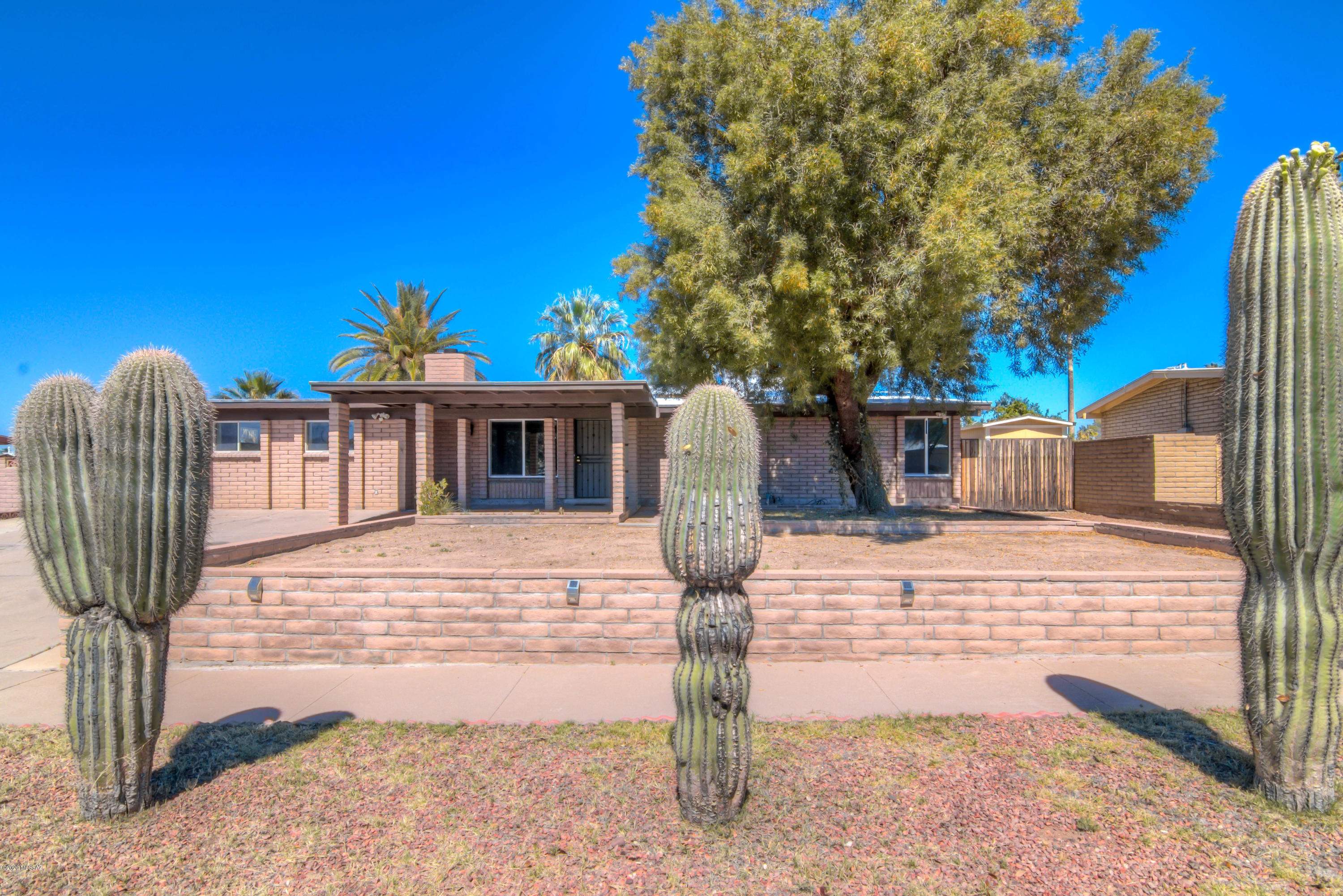 This stunning one-story home is on a large lot in a great NW neighborhood! Mountain Views and NO HOA!  From the beautifully updated kitchen to the gorgeous beehive fireplace in the living space to the enormous bonus room/family room, there is plenty of space for the whole family to enjoy! Recent updates include new ceramic tile flooring,  stainless appliances, newer dual pane windows and slider, recently coated roof, modern and stylish bathrooms!   Situated in a friendly neighborhood near great schools, dining, shopping and I-10, this home is sure to go fast!