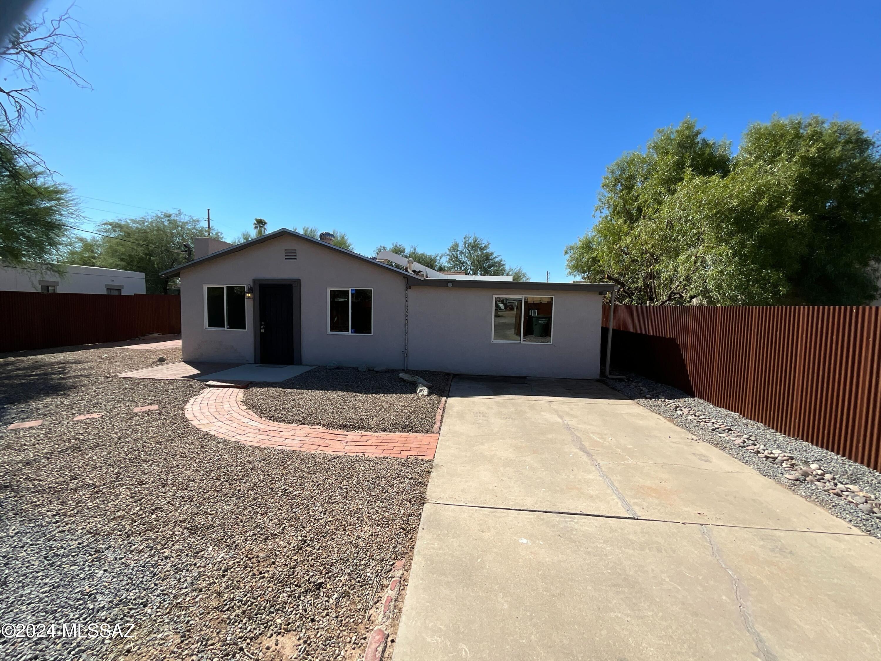 Welcome to this charming 3 bed /2 bath home located in central Tucson, featuring a fresh interior paint job in a soothing neutral color scheme. The kitchen is a chef's dream, equipped with stainless steel appliances. Step into the backyard to find a covered patio, perfect for alfresco dining or enjoying the outdoors. The fully fenced yard ensures privacy and security with a low maintenance landscape. Additionally, the property includes a storage shed for organizing tools and outdoor equipment. This home is a true gem, blending comfort and convenience. Don't miss this opportunity to make it your own!
