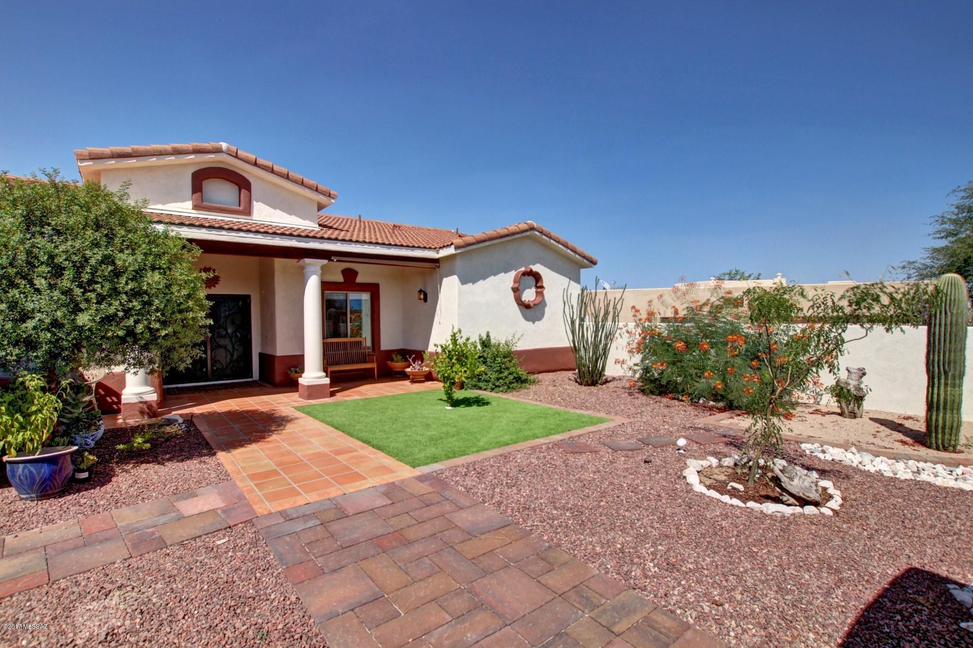 4 Bedroom 2 Bath home for sale in Sahuarita AZ.  This custom Dorn Home has lots of upgrades. Spanish Mediterranean styling includes high ceilings, covered entry way with tile roof offering spectacular view of Santa Rita mountains.   The large designer kitchen has lots of room for the gourmet or entertaining.  Concrete and tile floors and a beautiful fireplace add to the custom feel of this comfortable home. New Pool Filter, Pump, Pebble Tech Coating, Solar Heater, A/C, Hot Water Heater, paint Inside and out,
Stucco Wall, custom Gates, garage Doors. New Irrigation system, pavers and landscaping installed front and back. New Ceiling Fans and fixtures,  Washer, Dryer, Refrigerator, Dishwasher, Water Softener and blinds. Ducts cleaned and sanitized.
This home is ready to move in!