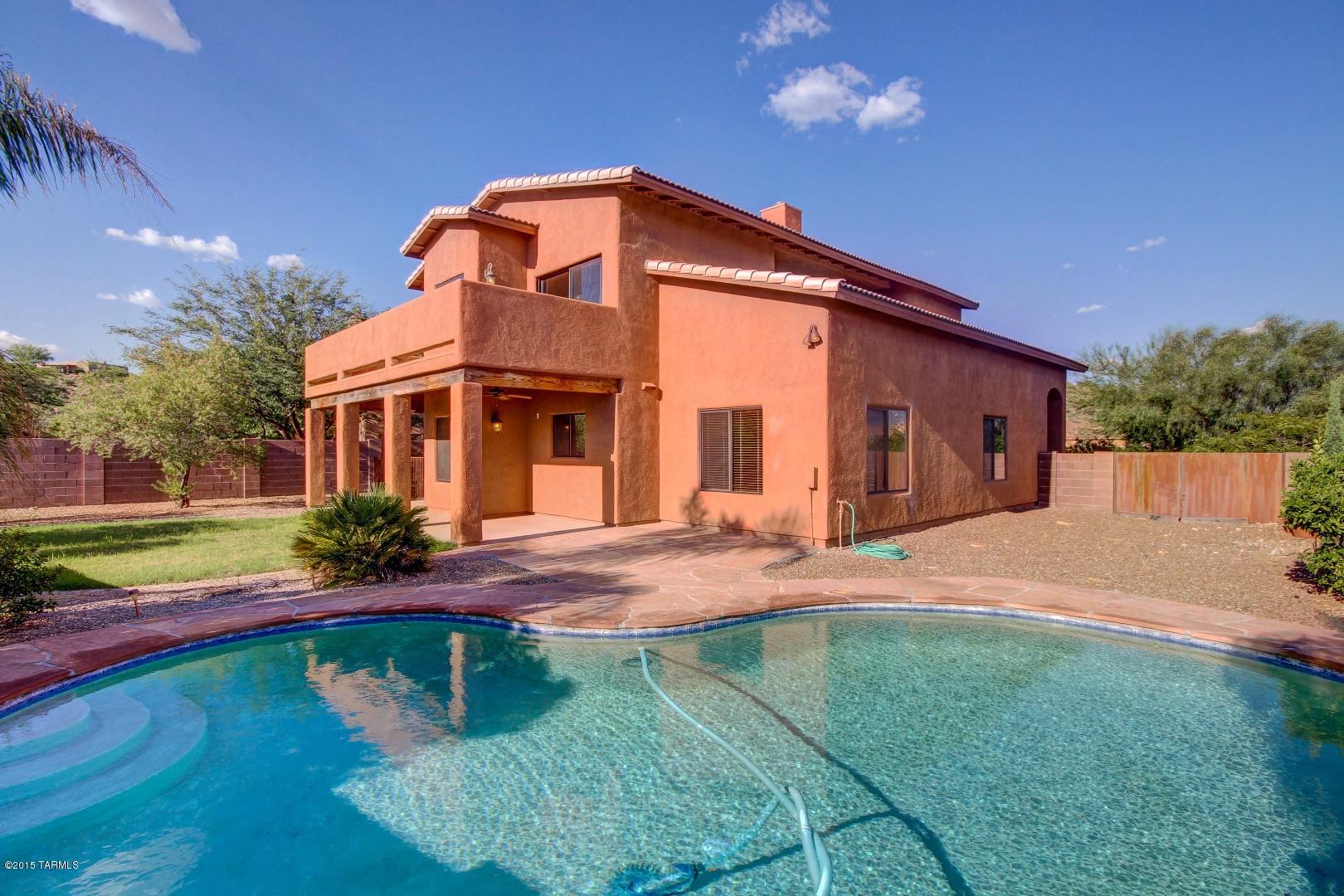 Incredible 5 bedroom floor plan. One bedroom and full bath downstairs perfect for guests/family. Soaring vaulted ceilings in the living room with a fireplace and stylish nooks. 3 car garage with openers for both bays. Master suite boasts large private balcony with gorgeous mountain views. Refreshing pebble-tec pool in the back yard with flagstone decking and a fireplace. Relax and enjoy with friend and family as you take in the gorgeous views of the Catalina and Tortolita mountain views. Separate gated side yard perfect for your four legged family member.