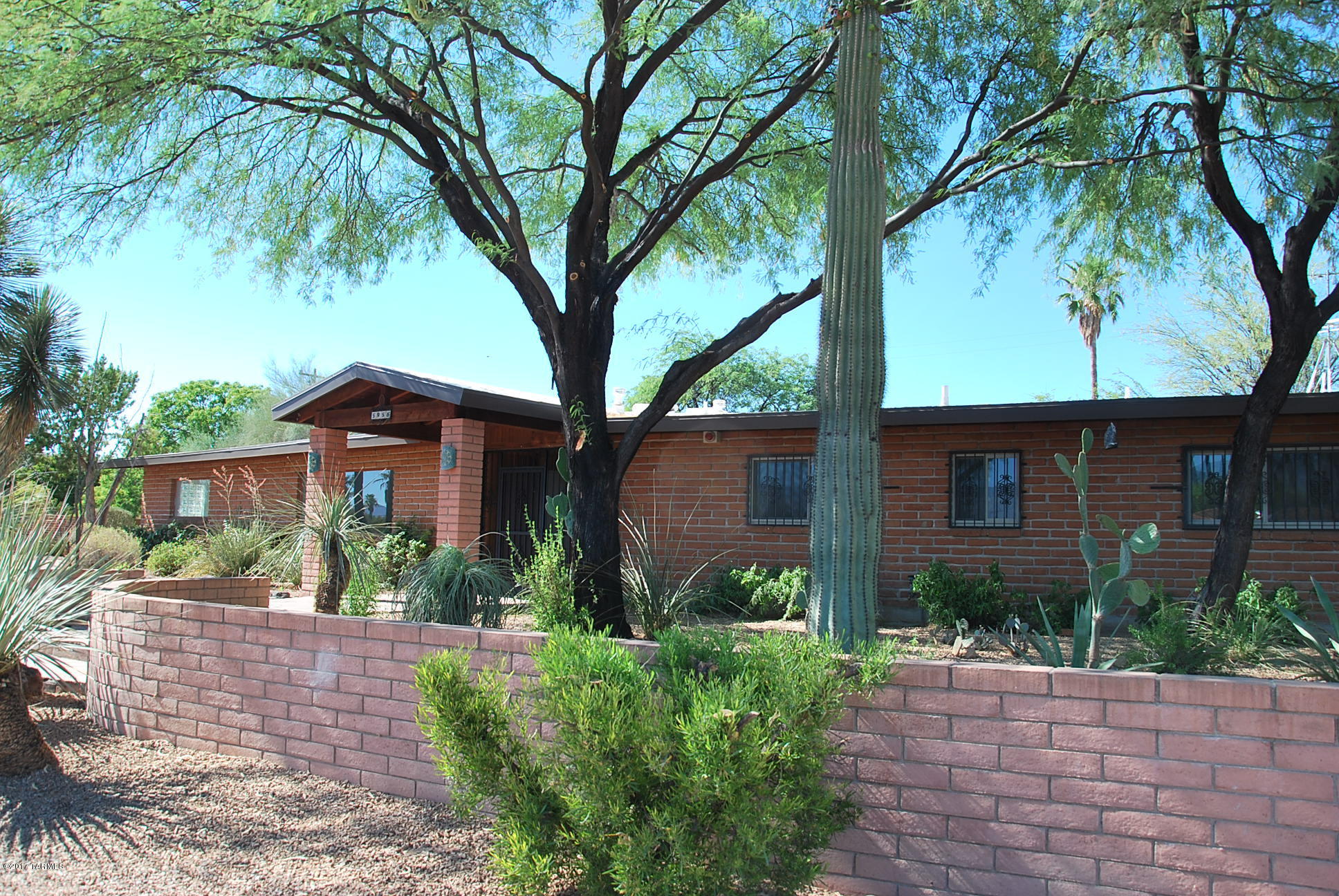 Wonderful mid-century ranch lovingly maintained & tastefully updated. This home is sited on .3 acre lot, lush w/mature landscaping. Recent updates includes: new master bath, freshly detailed kitchen & guest bath, wood look plank flooring in main living areas, many new light fixtures & doors in most rooms. All freshly painted! Great library-study with built-in bookcases, fireplace & French doors. Don't miss large office and 2 additional bedrooms and bath in east wing of home with private entrance: the perfect guest quarters/granny flat. Additional amenities include solar heated lap pool w/automated cover, separate 2 car garage w/large storage room and workshop. Nice poolside ramada, covered porch, and 21x22 breezeway offer shaded play areas for the young ones.