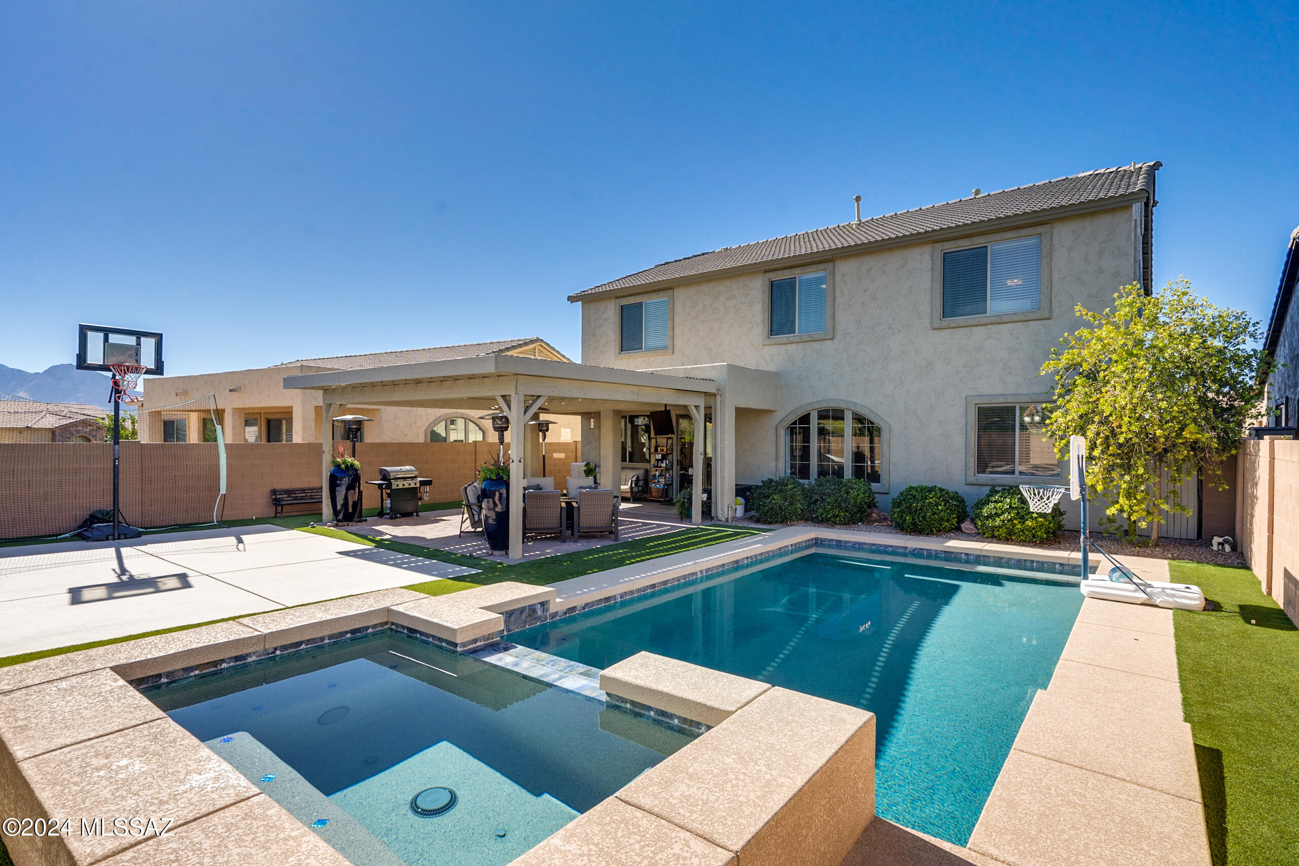 Discover your dream home in the heart of Oro Valley! This stunning 3,494 sqft residence offers a perfect blend of comfort, luxury, and convenience. Featuring 5 spacious bedrooms and 3 full baths, including a dedicated 1st-floor in-law suite with its own private entrance—ideal for guests or multi-generational living. Step into the open-concept kitchen, complete with a large island, stainless steel appliances, and ample counter space, seamlessly flowing into the casual dining area and inviting family room—perfect for hosting gatherings and creating lasting memories. The well-thought-out 1st floor layout also includes an open den with large windows overlooking the expansive yard and sparkling pool, while the entry welcomes you with an additional formal living and dining area for more intimate settings. Upstairs, a spacious loft awaits, perfect as a game room, home theater, or cozy retreat. Beyond the loft are 3 generous bedrooms, and an additional impressive master suite, which includes an oversized bathroom with double vanities, a soaking tub, and a separate shower. The walk-in closet will make any wardrobe enthusiast swoon! But the real showstopper is the resort-style backyard, a private desert oasis featuring custom landscaping, artificial turf, a large Ramada with a built-in TV, and plenty of space to lounge and enjoy the serene desert views. Whether you're lounging by the pebbletech pool & hot tub or entertaining under the shade, this yard offers the ultimate outdoor living experience. Located just 5 minutes from the Oro Valley Community & Recreation Center, you'll have access to pools, fitness facilities, tennis courts, and year-round activities. Plus, you're within walking distance to the nearby community park, making this home an unbeatable location for active lifestyles.
Don't miss out on this exceptional property, schedule a tour today and make this Oro Valley beauty yours!