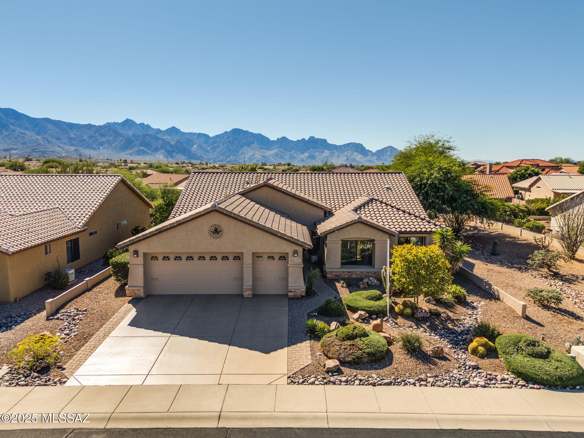 Welcome to this beautifully maintained 3BD/2BA home plus den, offering 2,399 sq. ft. of elegant living space in the desirable SaddleBrooke community. Designed with a thoughtful split floor plan, this residence features both a separate living and family room, providing the perfect blend of comfort and functionality. The chef's kitchen is a true showpiece, complete with granite countertops, stainless steel appliances, and abundant cabinetry, ideal for both everyday living and entertaining. The spacious owner's suite offers private patio access, a luxurious ensuite bath with a walk-in shower, and a generous walk-in closet. Enjoy serene outdoor living in the tranquil backyard featuring a covered patio, built-in BBQ, and gas fireplace—all set against spectacular mountain views. Home has 2x6 extra insulation and insulated garage for year-round efficiency. Recent updates include a new roof, HVAC system and carpet. Experience resort-style living in SaddleBrooke with world-class amenities including golf, tennis, pickleball, swimming, fitness, dining, and entertainment all just steps from your door.