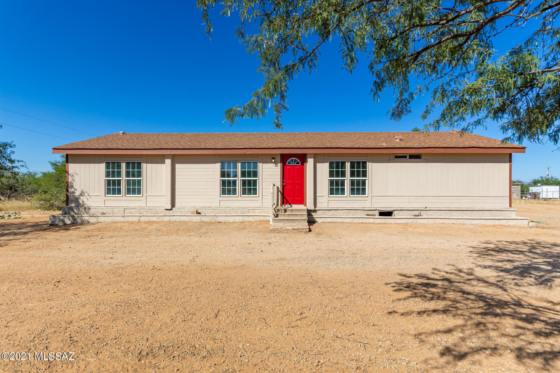 Beautifully remodeled 3 bedroom, 2 bath home with a fresh neutral palette inside & out. Turn-key with new: flooring, light fixtures, bathroom vanities, brushed nickel fixtures, new AC, and so much more beautiful finishes throughout. The great room is welcoming with a wood burning fireplace perfect for roasting s'mores in the winter . Arched doorways and partitions exudes elegance. Kitchen- complete with new stainless steel appliances and modern cabinetry.  Step outside into the huge yard with plenty of space to make it your own backyard paradise. Owner is a licensed agent.