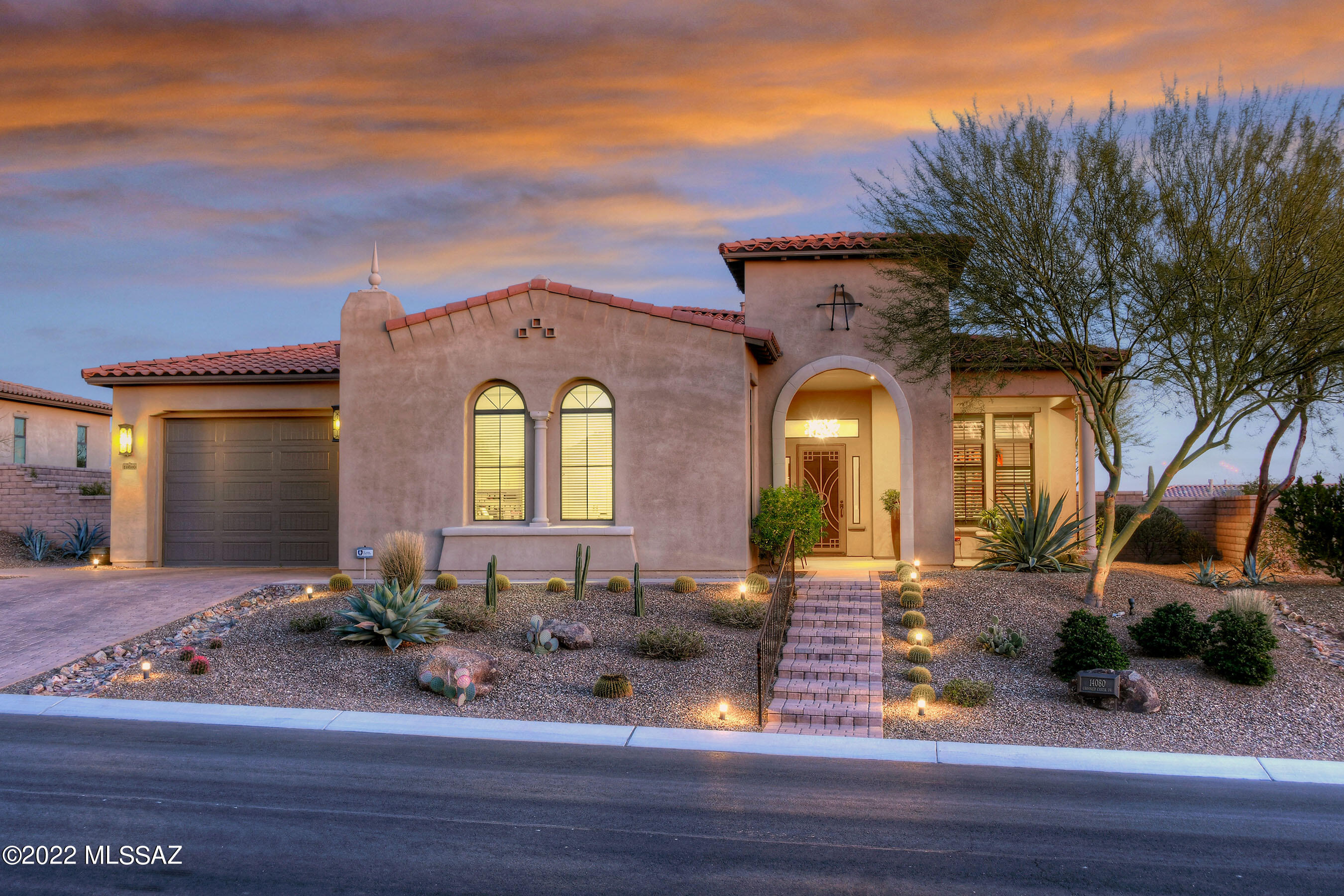 NESTLED IN THE FOOTHILLS OF THE TORTOLITA MTNS- GATED  *LOS SAGUAROS@ DOVE MTN*
ELEGANT EXPANDED ''MONTILLA'' MODEL IS FILLED W/UPGRADES & DESIGNER FEATURES! TASTEFULLY DECORATED- BRINGS SW FLAVOR TO MODERN DESIGN! WONDERFUL GREAT ROOM OFFERS NATURAL STONE WALL/CONTEMP LINEAR FP, ACCENT DISPLAY SHELVES, VANISHING DOORS OPEN TO OUTDOOR LIVING, ''12 FT'' CEILINGS THRU-OUT, UNIQUE COMBINATION OF MARBLE/ QUARTZ CTRTOPS & CONTRASTING WOOD CABINETRY, UPGRADED SS APPLIC & HUGE WORK ISLAND/BKFAST BAR...MAKE THIS EVERY COOKS DREAM! PREM OVERSIZED EAST FACING YARD- BOASTS SEVERAL TRAVERTINE PAVED PATIOS, MATURE TREES, EASY CARE- TURF, SOOTHING WATER SPILL &  PANORAMIC MTN VIEWS CREATE A RELAXING RETREAT! NUETRAL PORCELAIN TILE FLRS, CUSTOM WINDOWS TREATMENTS, 3 CAR/POSSIBLE WORKSHOP/ EXERCISE SPACE
