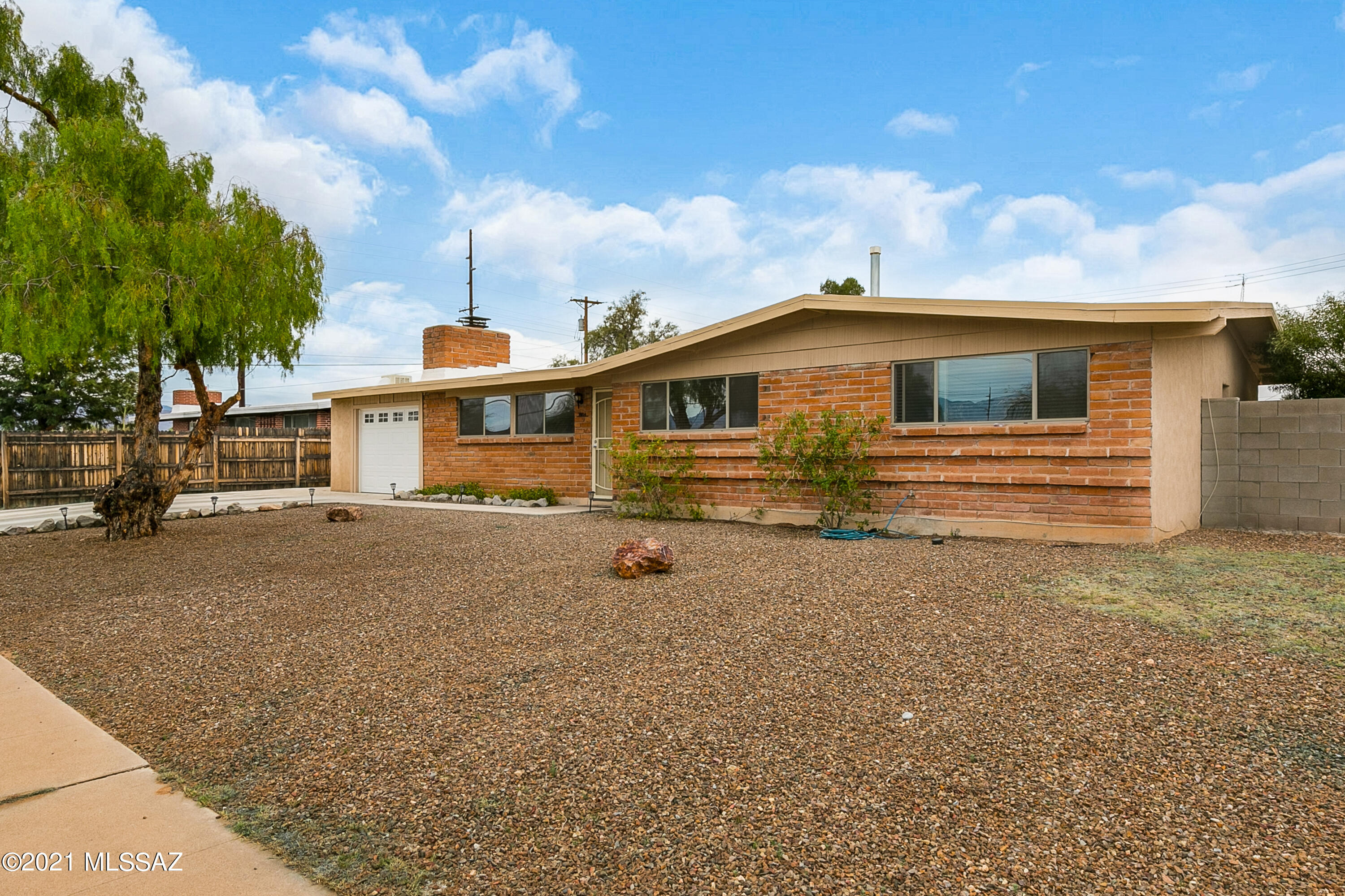 Seller will accept or counter within range $250,000-265,000. This midcentury ranch has everything and more! Large living room has charming fireplace with custom screen and bonus area that's perfect for a reading nook/office/den or formal dining area. Modern kitchen has stainless steel appliances, large island w/ seating, new cabinets, granite countertops and dining area. Both bathrooms have been updated. Newer HVAC, electric panel, dual pane windows, lighting & plumbing fixtures. Large backyard has secure, private block wall, covered patio, turf, and a shed. Oversized side gate allows drive through access for toys or additional vehicles. 1 car garage & wide parking pad. Laundry room has cabinets for pantry or extra storage. Neighborhood Park, Palo Verde, has pool, play ground & splash pad.