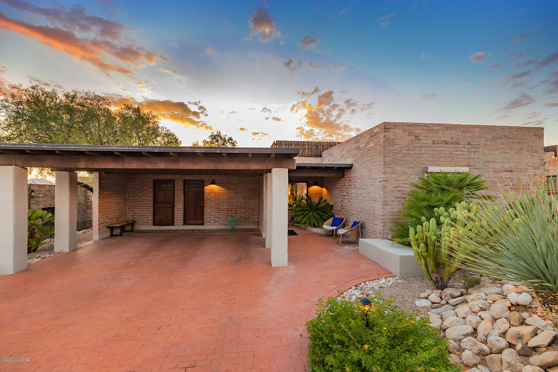 Location, location, location.  Charming quality built La Quinta burnt adobe still boasts the many timeless upgrades and charm.  Great open floor plan (living/kitchen & dining).   Burnt Adobe wood buring fireplace creates an amazing atmosphere while enjoying either the sunrise or sunset.  Remodeled kitchen with beautiful matte marble countertops, new Slate LG SS appliances.  Remodeled master bath includes matte black ceramic floors, white ceramic shower w/copper sinks & fixtures.   Tucson outdoor living at its best; sunset views, city lights and morning sunrise.   75 gallon solar owned hot water system.    Community pool just around the bend.  Low HOA fees. Minutes to Downtown, UofA, Banner.