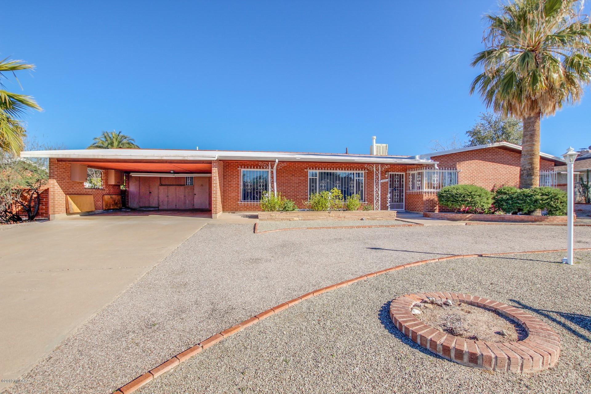 Spacious 4bd /3ba home centrally located on a large lot. Great curb appeal and circular driveway. This home has much to offer with large bedrooms,wood beam ceilings,open and bright plan over 2,400 sq ft. Separate bedroom and bathroom could be mother in laws suite or guest quarters. Additional interior bedroom could be added for potential assisted living facility. Extra large carport for parking and plenty of storage area. Very large and private back yard with extensive brick work, BBQ Grill and  covered patio area. Really must see to appreciate.