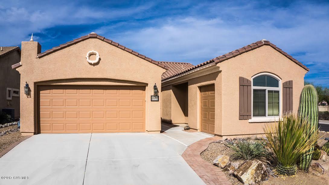 Exquisite Amado that is truly a step above! Enjoy attractive curb appeal from a corner lot literally across the street from the Sonora clubhouse & athletic facilities. Home has extra golf
 cart/motorcycle garage w/ extra storage for all your toys. Upon entering the home, be prepared for a treat! Some upgrades & enhancements include gorgeous custom off-set tile, newer
 SS Kitchen-aid appliances, professionally installed home theater & surround-sound to living rm & back patio, Crime Guard security doors, fresh exterior paint. Split bedroom plan.
 Master features gorgeous rustic wood laminate, bay window & classy shades. Newer washer/dryer stay. Beautifully landscaped back yard w/ covered patio. This home has been
 immaculately maintained & it shows! See list of enhancements in documents. Come enjoy Rancho Sonora by Del Webb, a fabulous active adult community in Rancho Sahuarita!