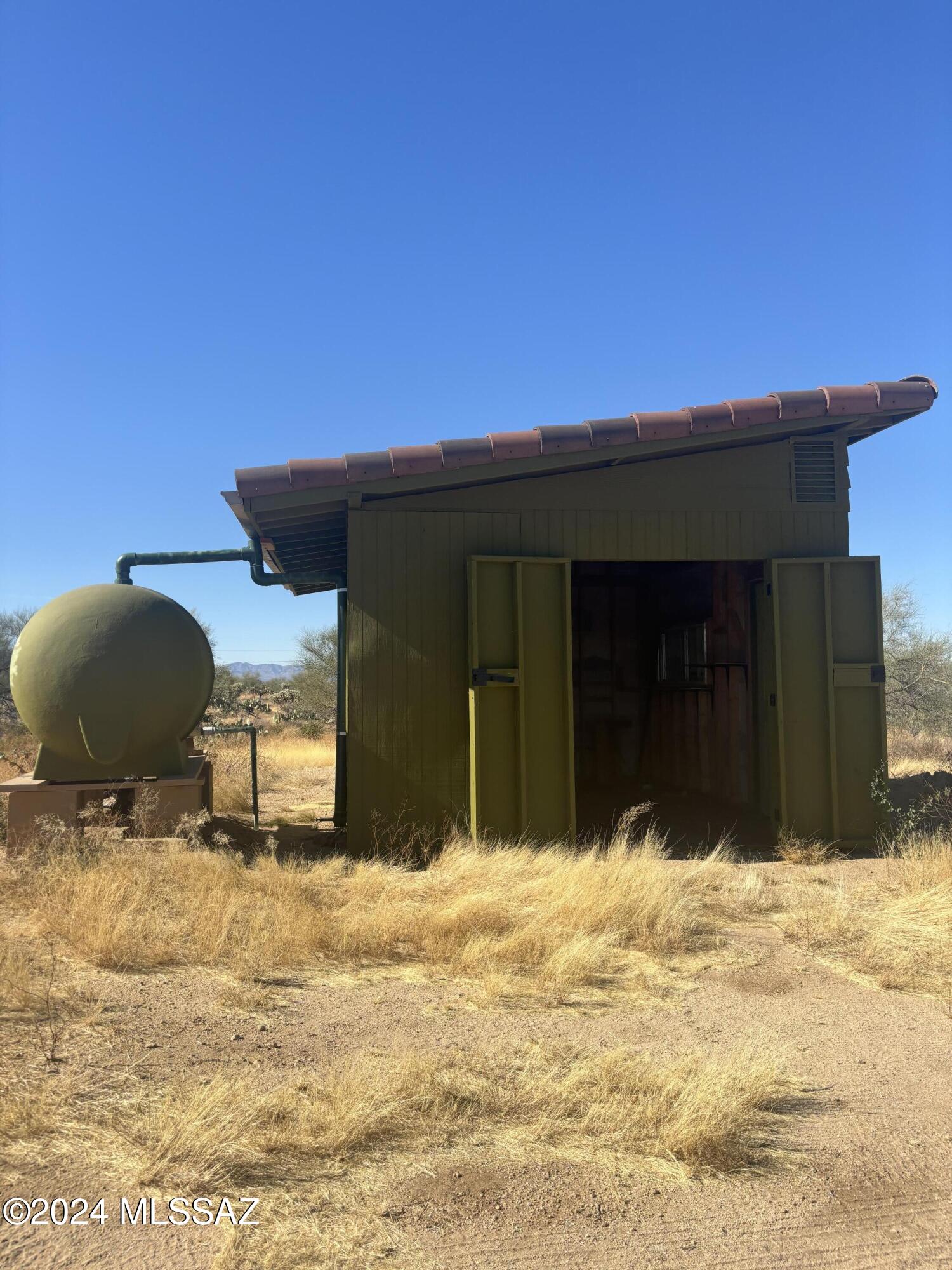 Build your dream home on this serene desert oasis property on this 4.89-acre lot in Diamond Bell Ranch, adjacent to state trust land, your scenic backdrop is protected. Home has SEPTIC, shed with water catching and water tank, barbed wire fence. Enjoy panoramic views of the Tucson Mountains, the Santa Catalinas, and Baboquivari Mountains. A perfect investment away from the city life, in tranquility and natural beauty.  Horse property, Star Gazing, World Famous Kit Peak Observatory, Ryan Airfield Nearby, Natural Southwestern Vegetation Abounds, Beautiful Mountain and Sunset Views, 3000' Elevation, Quiet & Private. Enjoy the outdoor lifestyle with ATV's/RV, animals!  2 adjacent lots for are for sale. Be sure to see the best directions in the images.
