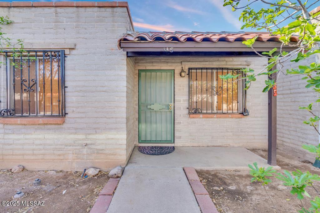 Affordable Housing -Here is an opportunity for investors, first time homebuyers, snowbirds, to invest or move into this well maintained 754-sf, 2 bedrooms, 1 bath open concept condo with tile throughout. This home offers an updated bathroom, newer Central Air and Gas Furnace (3 years ago), plus an added water softener, and a reverse osmosis system.  You will have one assigned private car port, with an open car parking covered patio, fenced yard and storage with washer and dryer hookups. HOA covers water, sewer, trash, roof, pest control and community pool. Close to the University, shopping and restaurants. Per the HOA NO Rentals allowed.