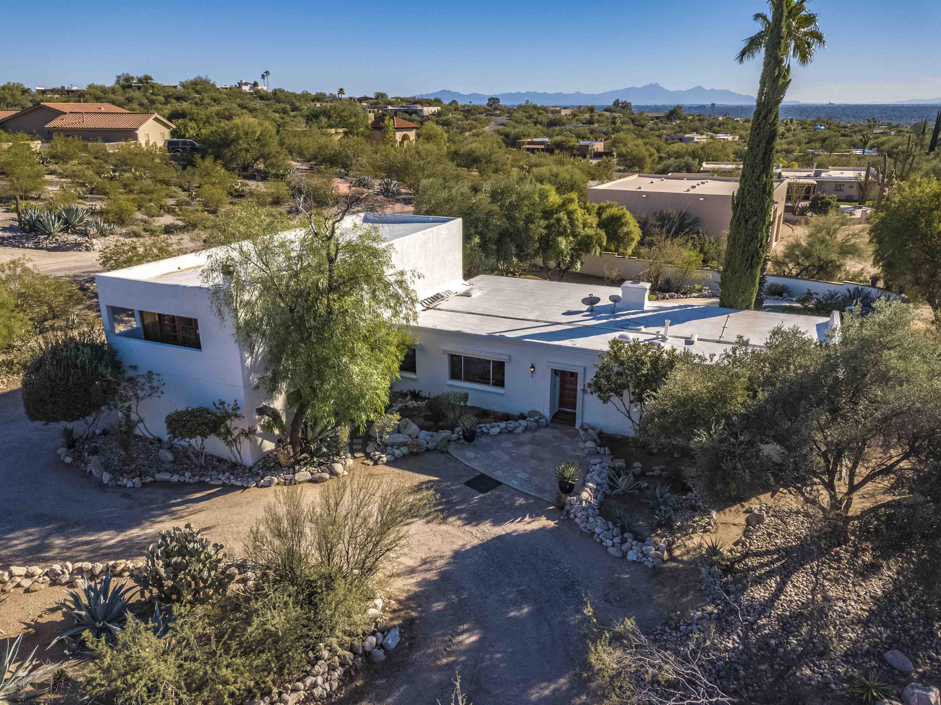Classic Foothills home sits on  just under one acre in popular Flecha Caida Ranch Estates. 4 bedroom split plan offers a true Master Suite with den,  3 guest bedrooms & 3 baths. Kitchen, living areas & 3 bedrooms on the main level with no interior steps. Master Suite with separate flex space (den/sitting area/exercise space) two balconies and Master Bath are upstairs.  Living and dining rooms have North facing mountain views. Large enclosed rear yard with pool, masonry fence and custom iron double gate. The two car garage is heated & cooled, has storage PLUS an extra room  that could be an office or workshop.  Quiet street, private lot, easy access to all major conveniences. One horse allowed on the property per the CCR's. DISTRICT 16 SCHOOLS!