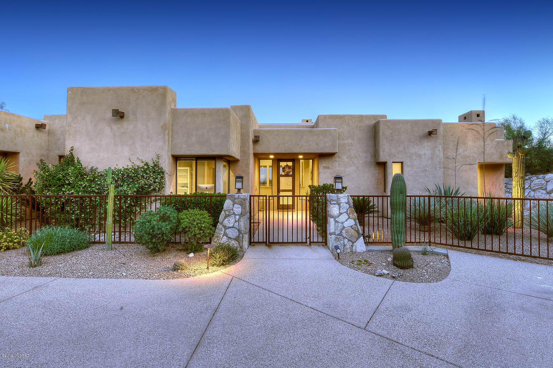 KEVIN HOWARD DESIGN located in prestigious Catalina Foothills! 4bed (or 3/office) 3.5 bath split plan CONTEMPORARY home. Quiet & Private location OFF CAMPBELL in small enclave of homes. Enter in to open living/dining room w/ travertine floors, gas fireplace & floor to ceiling windows highlighting Mountain & City views. Light & bright Kitchen w/ high ceilings w/ stainless LG appliances, granite counters, breakfast bar & breakfast nook + 2 pantries. Spacious Great Room w/ room to hang out.  Master suite w/ gas fireplace, wood floor, door to backyard, large walk-in closet. Bath boasts huge soaking tub, walk in shower, double sinks. Resort like yard w/ sparkling pool & spa, turf, gardening space & wide open to views. Tranquil Beauty.Dist. 16 Schools. N/S exposure. 3 car garage. Storage Galore!