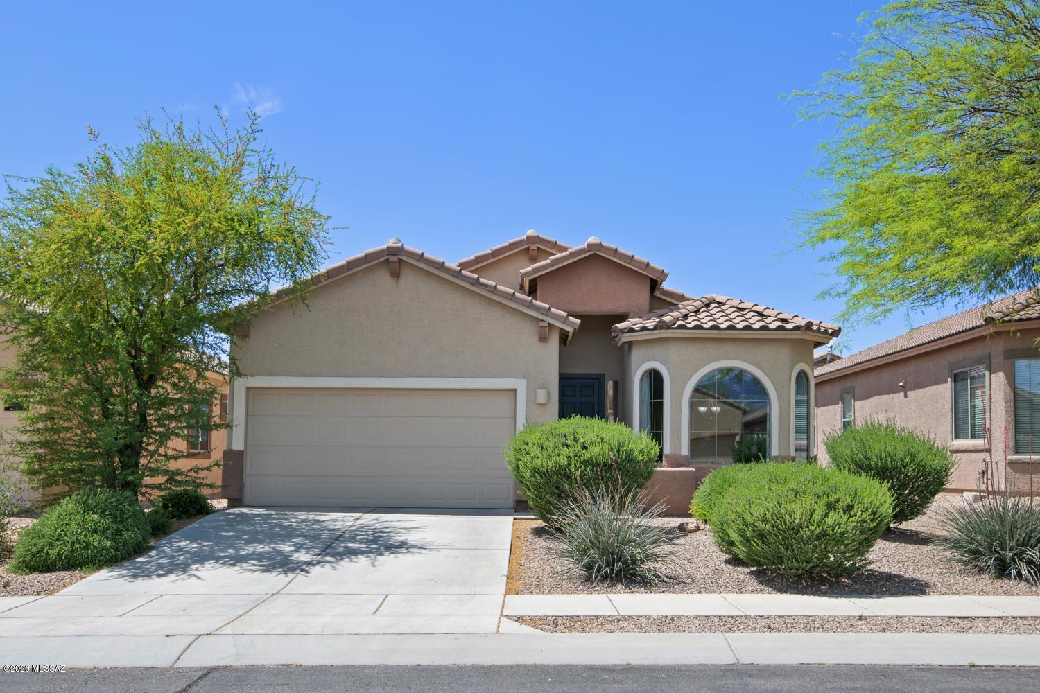 Fantastic home located in the Heart of Oro Valley, AZ.  Everything you need, including tons of walking trails, parks and great schools for the kids close by. You'll really enjoy the split bedroom plan with a beautiful master suite including large en-suite with dual sinks, walk in closet and luxurious garden tub to relax in. Spacious kitchen with 2 breakfast bars, brand new dishwasher, spacious pantry, and tons of counter space to prepare family meals. Admire the Catalina mountain views from the beautiful dining room window. Back yard has a wonderful covered patio to enjoy your morning coffee; the low maintenance yard gives you more time to enjoy the fun things in life. 2 car garage and low HOA fees make this a MUST see home. Check out the 3-D tour and floor plan at your fingertips.