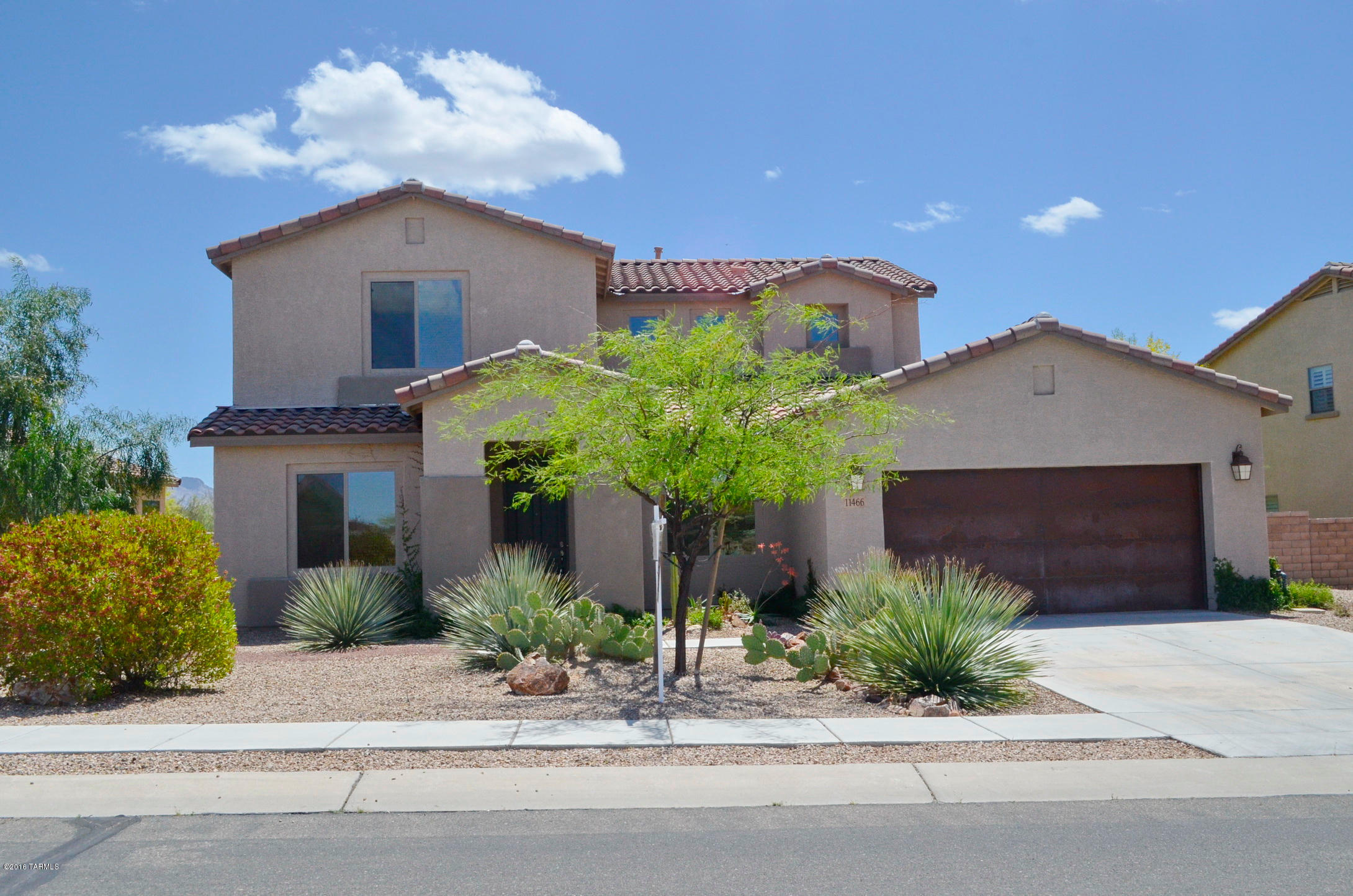 Beautiful, move-in-ready home w/many fine features:  granite kitchen counters, 18'' cabinets, GE kitchen appliances (all convey), butler's pantry, kitchen crown molding, gas cooktop, elegant wood & wrought iron staircase, upgraded 18'' tile, his & her walk-in master closets, dual zone heating & cooling units, cable outlets in all rooms, upgraded lighting, all 3 bathrooms w/dual executive height sinks, rustic metal garage doors and more.  Ideal east facing premium oversized backyard backs to natural desert habitat.  Lovely gated community.  Close to shopping and coming-soon new 18 acre park. Downstairs room can has multiple uses:  office/den, craft room, exercise room or a true 5th bedroom.  Home has 3 full bathrooms.  This premium  location awaits a new owner.