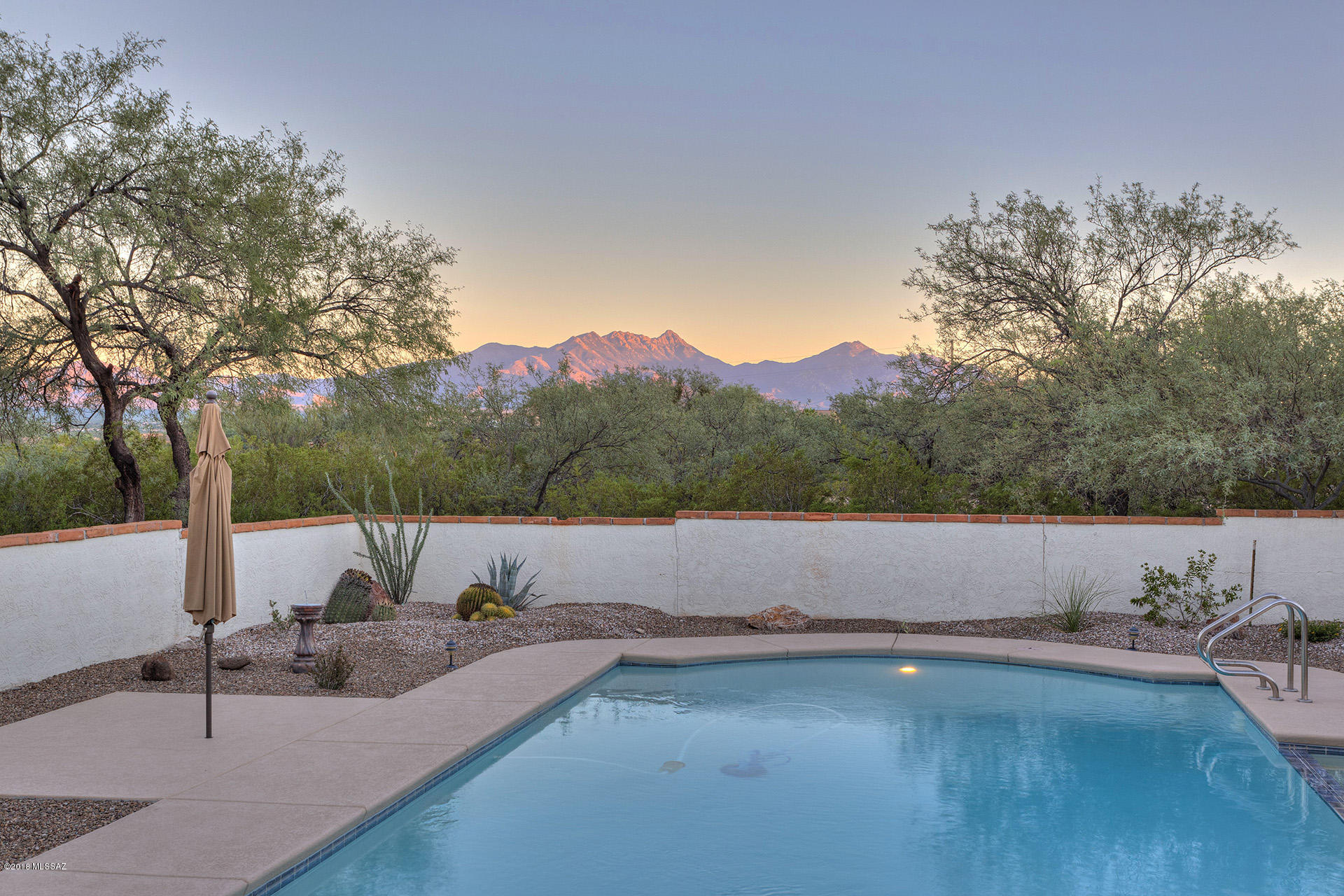 Wanting more land for your rec vehicles/RV? Tired of your HOA? Need more privacy? Still want a convenient location for shopping and dining? Then you MUST see this home.  Enjoy gorgeous mountain views, while sitting on the huge wrap around patio or while swimming in the beautiful pool. Inside you will enjoy an updated kitchen with high-end appliances and quartz counter tops. Your baker's pantry extends the  kitchen with storage and food prep space. Family room with fire place also has sliding door for access to rear patio. Formal dining room includes wet bar and lots of room for entertaining. Large bonus room is perfect for rec room, home office, or studio guest quarters. Extended lot has room for RV parking and/or other rec vehicles on nearly one acre lot. This house has so much to offer!!