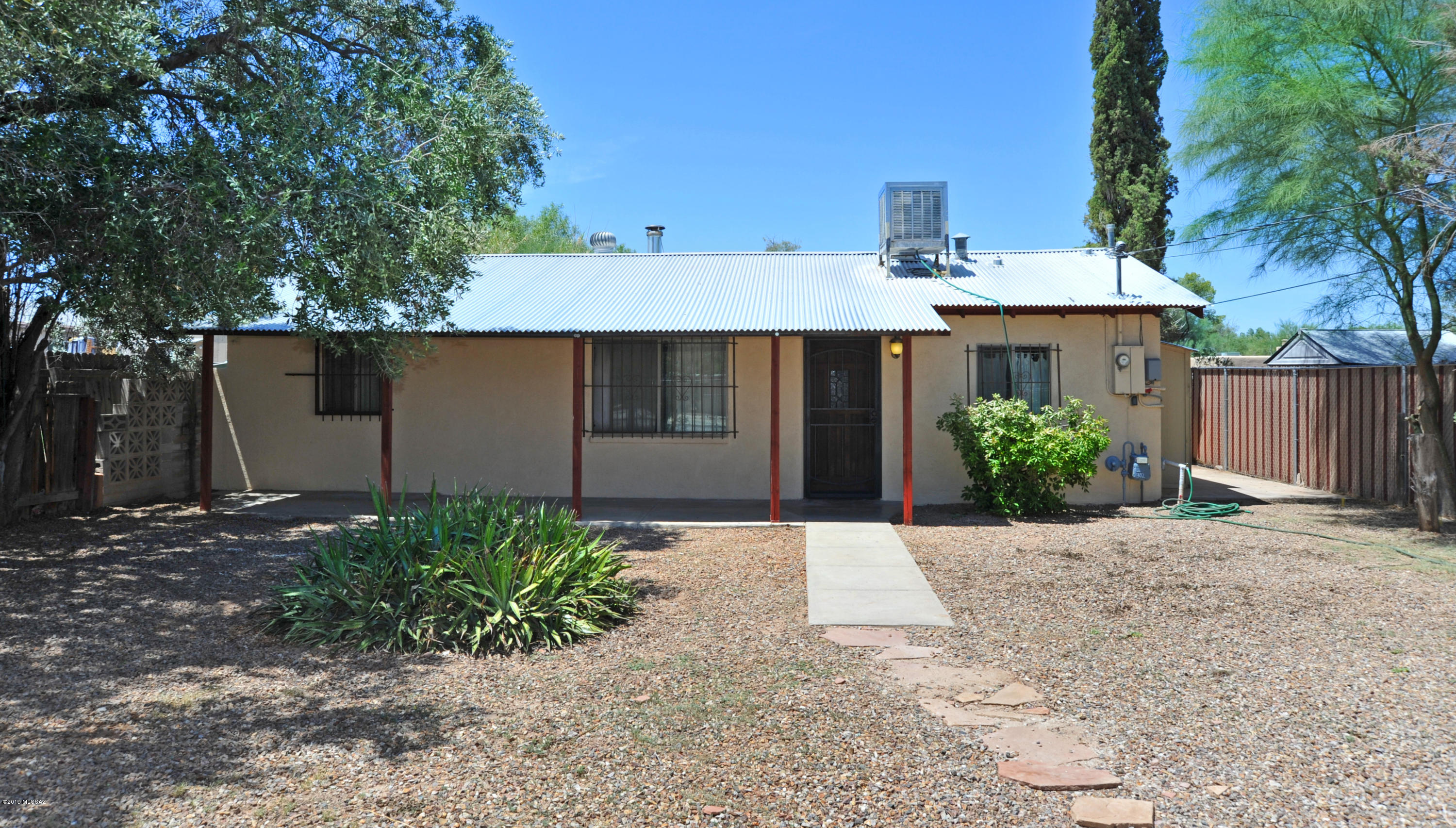 Completely remodeled bungalow with modern metal roof in perfect Central location! Open, spacious plan with hand textured walls, recessed lighting, dual pane windows & nice ceramic tile. Spacious living room with wood burning corner stove & updated kitchen with corian countertops, breakfast bar, separate pantry & stainless steel appliances. Updated bath with nice corian countertops & tiled shower surround. Extended front covered patio on huge R2 lot. Great opportunity to own & have plenty of privacy or build and gain income.