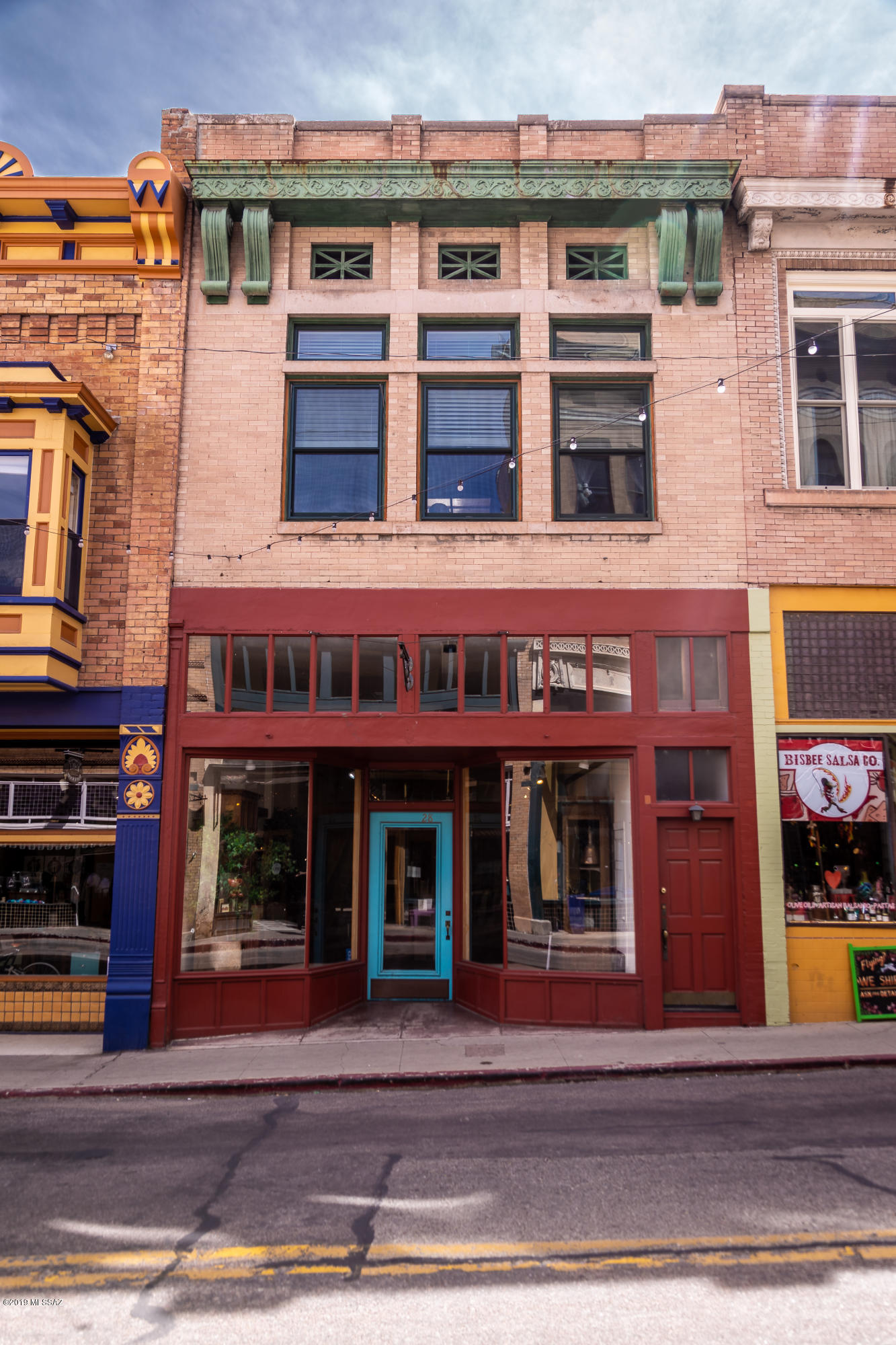 28 Main Street is a very unique property situated on the south side of lower Main Street in the Heart of Historic Old Bisbee.

Zoned C-4 Mixed Use. Currently use is  ''Commercial/Residential Mixed Use''

The Commercial retail space downstairs is 1500 sq ft and is currently set up as an upscale art gallery and gift shop with 14' ceilings and rustic pine paneled walls and exposed red brick. Street level access in the front/rear, and most importantly, one parking space at the rear finish off this truly unique turn key business.

The 1500sq ft residence upstairs is quite grand with its12ft high ceilings and a large skylight that illuminates the beautiful maple hardwood floors. New High-End Windows with unobstructed mountain views.  So many upgrades throughout this property.!