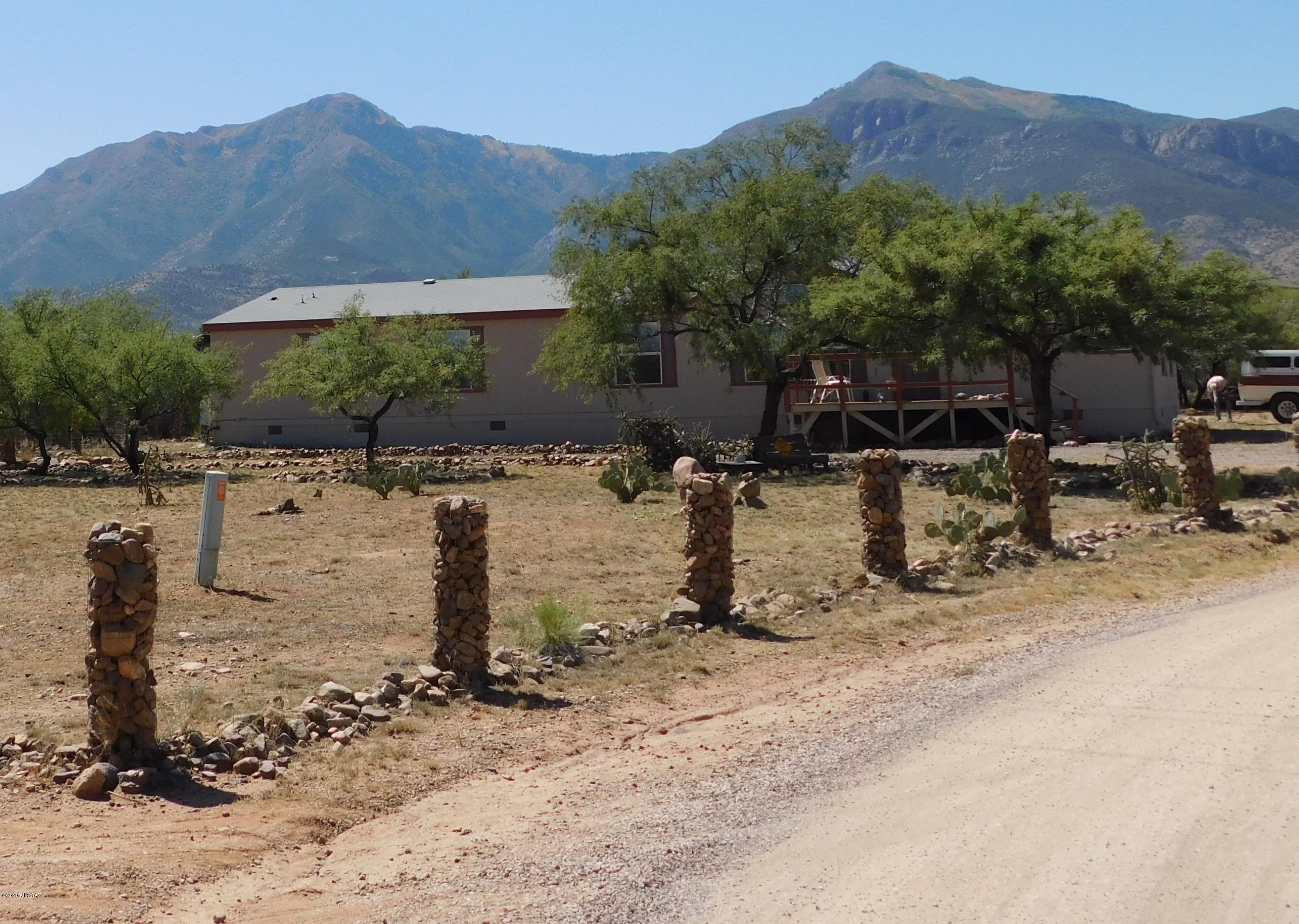 Million Dollar Views on an acre overlooking the Huachuca Mtns / Ramsey Canyon area of Hereford.FABULOUS 2400 sq.ft. Palm Harbor with probably the most amazing floor plan I have ever seen in ANY 2400 sq. ft. SFR!!The Open floor plan is great room upon great room with a gourmet kitchen in the middle! Stainless appliances including newer refrigerator and cabinet space galore thought the entire home. Gas (Propane) appliances are in the home including the hot water heater which is such a smart way to go - but electric available too. All AC and many ceiling fans throughout the home with heat currently The heat throughout home is forced air, so a combo of propane and electric (cannot be switched to only elec).4 bedroom - split floor plan / 2 Bathrooms and a BONUS Baby room or office or or exercise room off of the huge master. Garden tub and separate shower in the master. This home is services by Liberty Water Company - not a well share - approximately $26.00 a month for water depending on usage- you read that right! There are two decks to enjoy some of the best views in Cochise County! Back deck is 16x30 and the front deck for East facing views for coffee time is 8x16.There is a fully enclosed extra large doggie run plus an enclosed hen house. Low care yard because all you need are the spectacular views. Plenty of room for RV's and car enthusiasts or gardeners too. THIS IS A MUST SEE HOME & PROPERTY! It is beyond FABULOUS! Washer/dryer and propane tank do not convey. Propane tank will stay thru inspections or the buyer can purchase it for $800.00