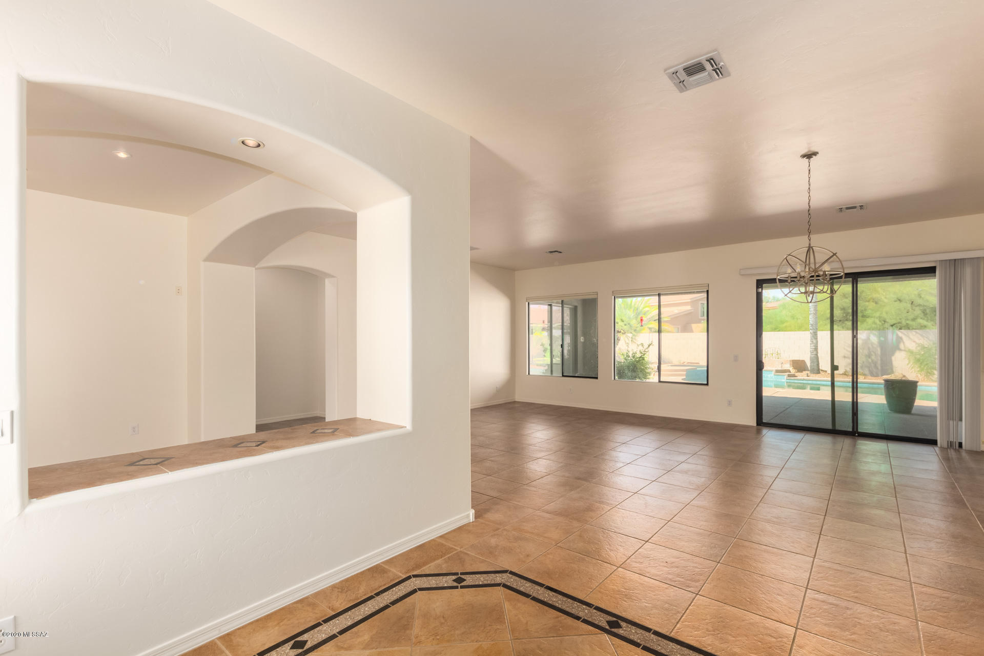 FRESHLY PAINTED INTERIOR  & MOVE IN READY!  Gorgeous Home in the desirable Community of Mira Vista. Resort style backyard setting is an entertainer's dream w/a sparkling heated pool, spa, built-in BBQ, covered patio, colorful plants, & swaying palm trees. Spacious open floor plan, soothing palette, beautiful tiled floors, large den, window blinds, & upgraded lighting. Family room fireplace, ceiling fans, media alcove, & patio access. Granite kitchen counters/backsplash, center island, breakfast bar, pantry, SS appliances, & plethora of wood cabinets w/hardware. Handsome wood grain laminate flooring in the 3 bedrooms.  No carpet in this home!  The outside of this home has been painted in the last year. 3 bedrooms, ample closets, & 2.5 baths.  Grand master retreat boasts patio access, tiled floor, walk-in closet, & separate shower and bath.