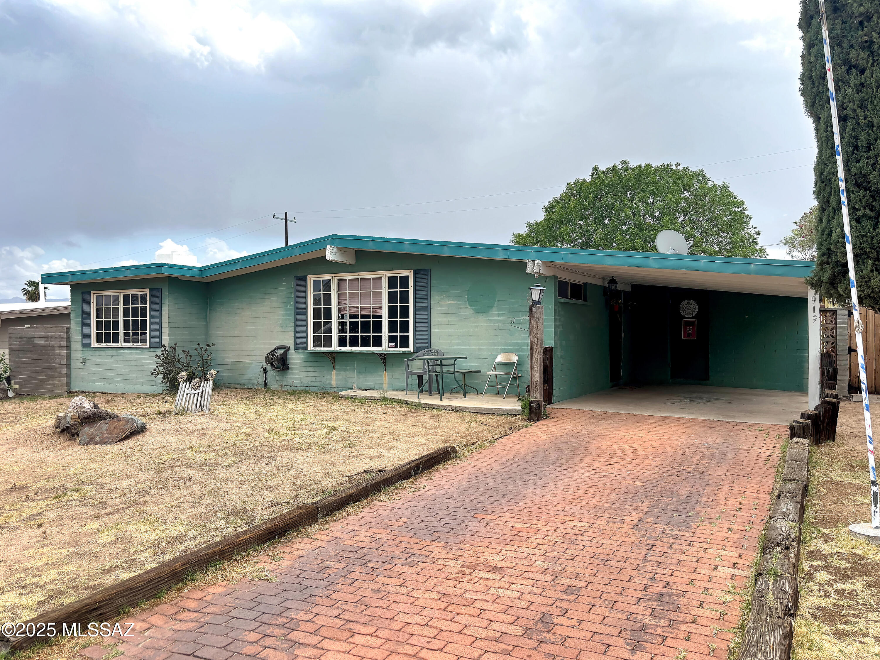 Charming 3-bedroom, 2-bath home with great potential, ready for your personal touch. Features include a spacious, block-fenced backyard with alley access, two unique sheds (a ''he shed'' and a ''she shed''), and a welcoming paver driveway. Relax on the covered paver patio and take in beautiful mountain views. Some TLC will make this home truly shine.