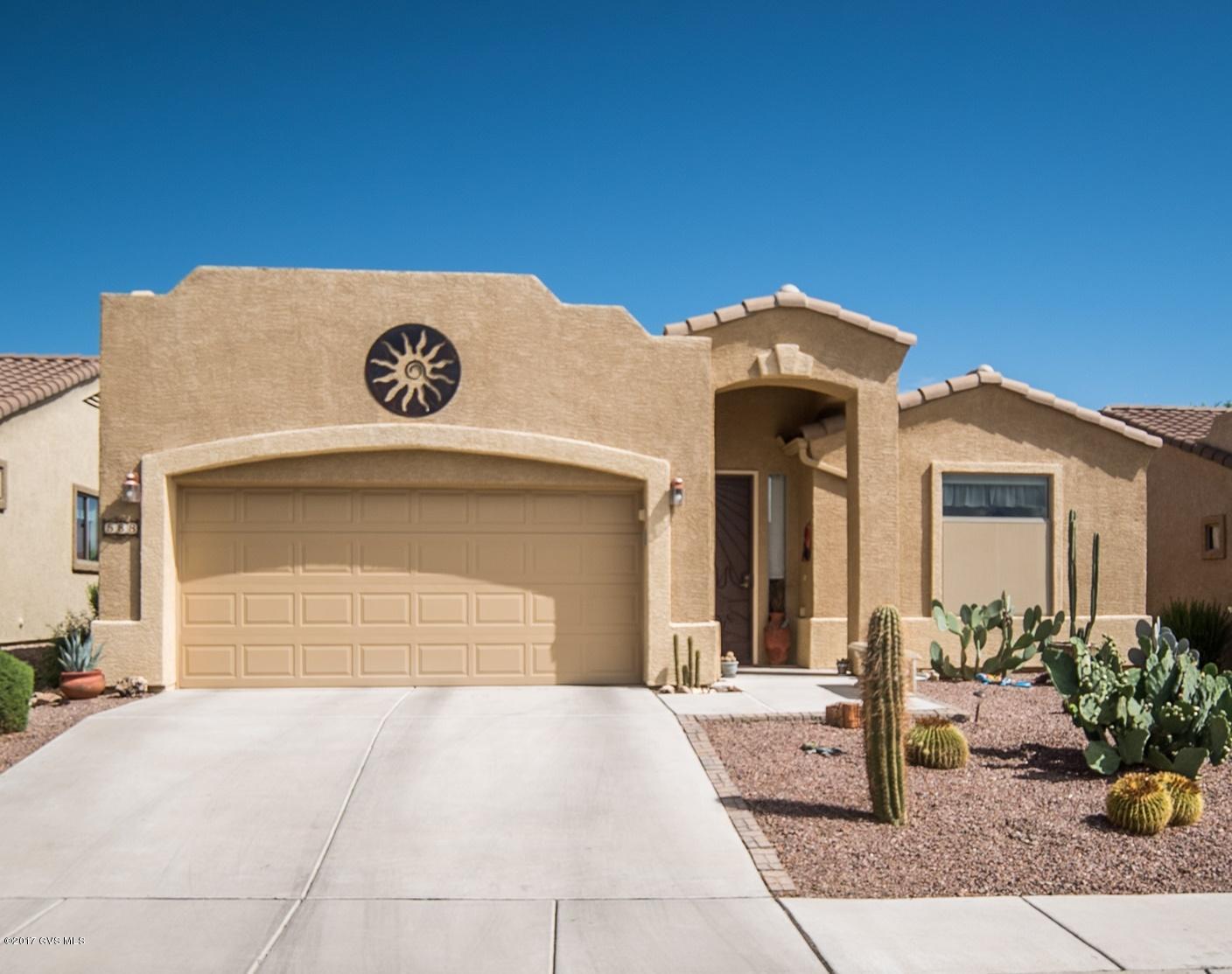 Exceptional home with great curb appeal featuring multiple pitched roof lines combined with an Alamo style parapet wall and desert landscaping convey a southwest feeling. As soon as you enter the foyer, you will notice the beautiful arched double wooden doors leading to an office area for catching up on bookkeeping or relaxing with a favorite novel. Warm earth tone floor tile, set diagonally, will lead you into an expansive great room with cathedral height ceiling lines delivering spatial airiness. The chef's delight kitchen features solid granite countertops, top of the line stainless appliances and an under counter single basin sink with a professional grade gooseneck faucet. There is plenty of room at the serving island to visit with friends while preparing dinner. Then, after  dining, move the conversation into the great room with a cozy corner fireplace and entertainment/media niche designed to display your favorite art pieces. Your master bedroom is set on contemporary wood plank tile flooring with a bay window alcove and serene color accent walls. The roomy master bath allows for a separate tub and glass shower enclosure plus, his and her sinks. Do you enjoy sitting outside in the fresh air? Great - your screened patio will provide you fresh air and cool shade as you relax on your patio in total privacy. Easy care living as the HOA takes care of so many things which will give you much more free time to do what you want to do!
