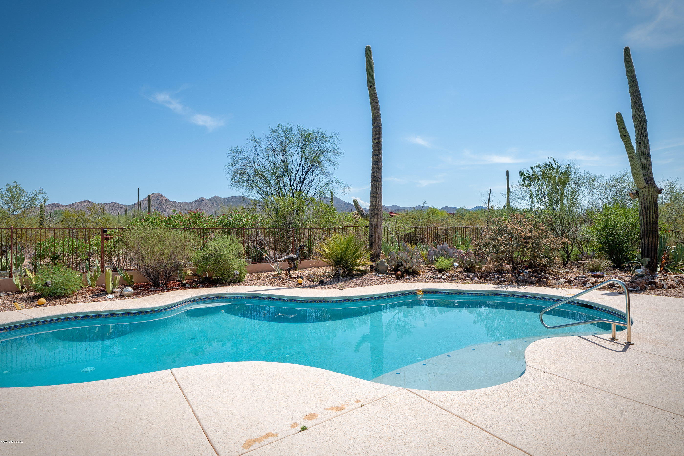 Affectionately dubbed ''Rancho Relaxo'', this desert gem is designed for you to feel like you're outside even when inside. Situated on a 4.3 acre lot, this property is perfect for the buyer who wants privacy & views.  Custom built home with a Contemporary Southwest flair features 3 bed/ 2.5 baths & a bright & open floor plan w/ natural light pouring in. Gorgeous kitchen w/ maple cabinets, granite countertops, & large island perfect for entertaining. Split floorplan with two large guest bedrooms & a large master suite big enough for a seating area around the cozy beehive fireplace. ''His & hers'' closets with a large bathroom featuring walk-in shower & dual vanities. Tons of storage throughout including a security room off the master bath. The resort like backyard has an extended covered patio, built in kitchen, and refreshing pool all surrounded by the mountains and natural desert landscape. This one is not to be missed!