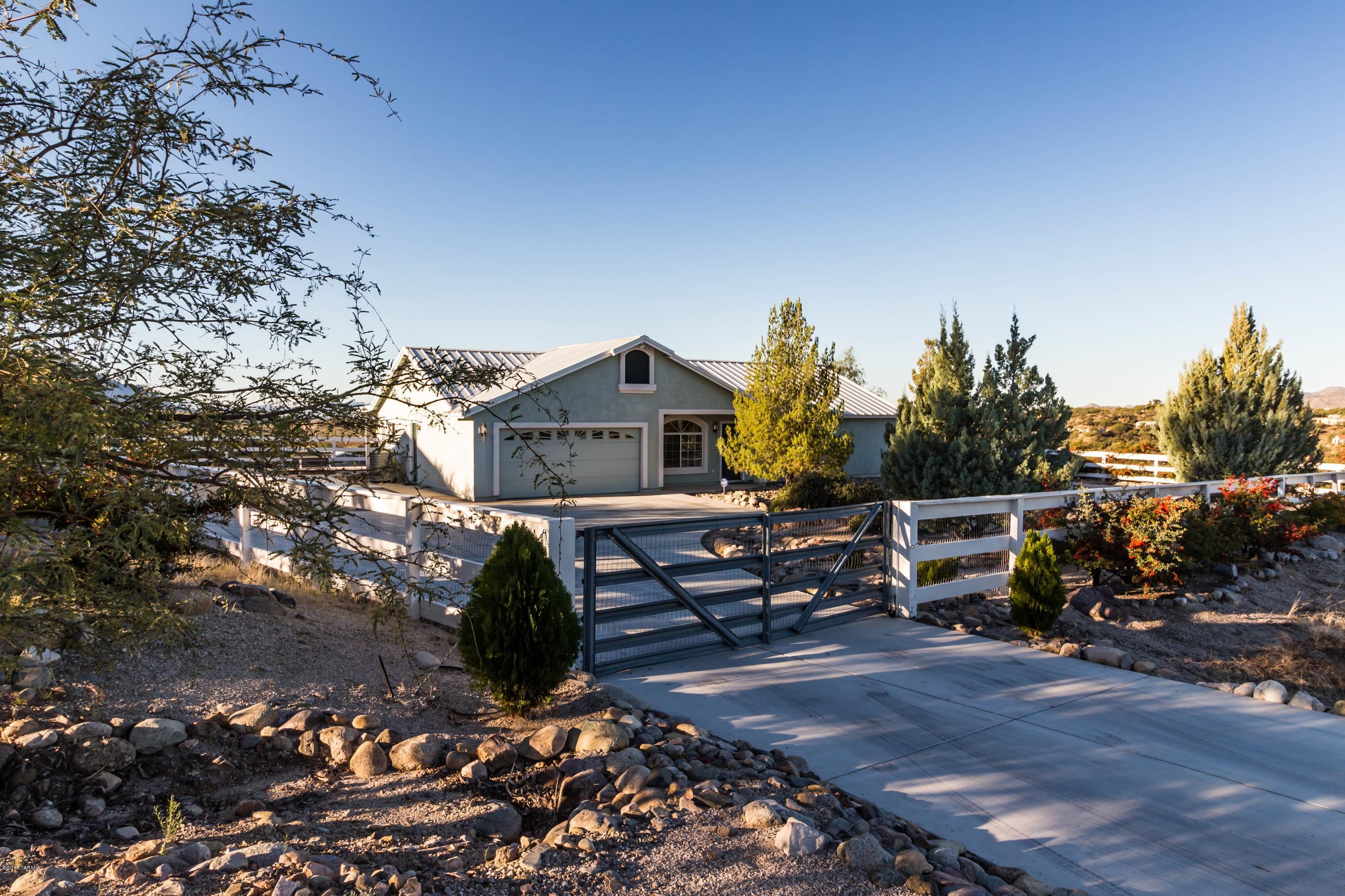 Solid, site built 1608 sqft home located on private, fenced, 1.13 acre lot in Catalina.  Sitting high on the hill & screened from the paved road by mature pyracantha & fir trees, the home offers mountain & valley views.  The large, functional kitchen features a breakfast bar & dining area with walk-out to the covered, back patio.  Ceramic tile floors are in all wet & traffic areas, & all 3 bedrooms & the living room are carpeted. The Master suite features a three piece bath & sliding doors to the back patio & hot tub. There is a powder room off the laundry room with direct access outside. The two car garage houses storage cabinets & a large work bench.  Recent upgrades include the extensive poured concrete drive, metal roof system & solar assisted heat pump.