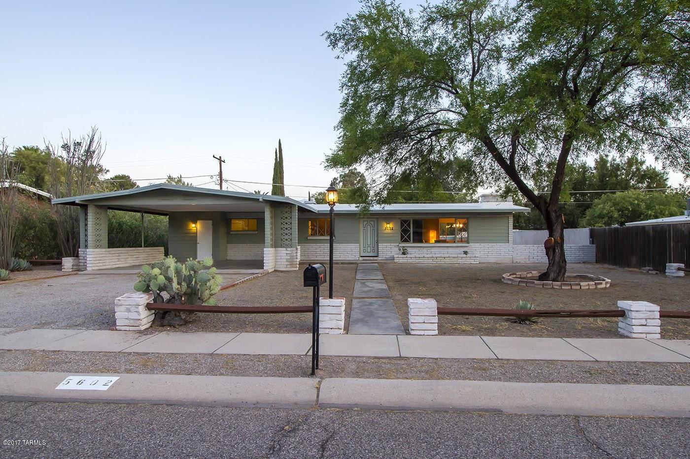 This 1957 Burnt Adobe's  exterior retains the original clean lines of this classic Mid Century architecture, While the interior has been updated with new kitchen, bathrooms and  Flooring though out. The large open Living room with corner brick fireplace. Spacious Kitchen with breakfast Area and with brand new stove microwave and dishwasher.  The Master bedroom opens out to the back porch and a perfect patch of grass. Conveniently located near shopping Historic Fort Lowell Park, TMC