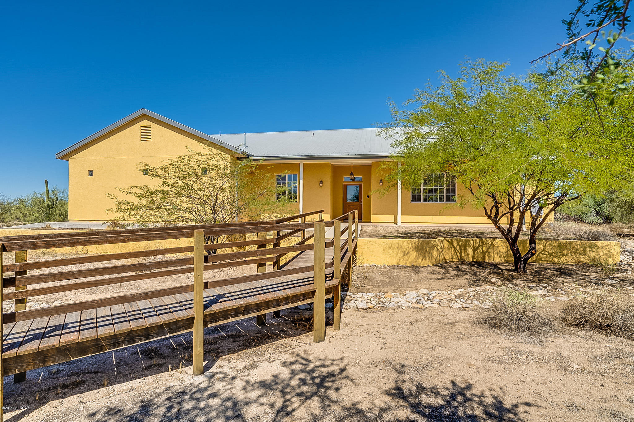 Rare Find, Custom construction 2804 SqFt home located on 3.3 Acres! Mountain Views of the Catalina & Tortolitas.  Great floor-plan w/ 2 Master Bedrooms, additional bedroom and large office/den that has a closet that could be 4th bedroom. Flat lot in horse friendly area. NO HOA or CC&Rs.   Features: Beautiful concrete floors throughout, High Ceilings, bright kitchen w/ butcher block large island for prep including prep sink & tile countertops, tons of storage in Maple cabinets. All Appliances included. Double Oven, Gas cooktop. Gas fireplace in the living room. Central Vac. Lower light switches and handrails for handicap accessibility. Metal roof.Oversized 2 car garage with large storage room.  Rv hookup for 30 & 50 Amp electric & Rv dump ready for your RV or visitors. Priced to sell fast.