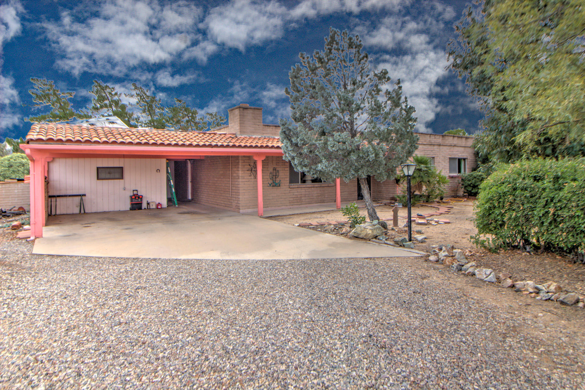 Living in the Southwest at its' finest. Unique, natural are with all round lots allows privacy and beauty. Artfully painted colored walls make this roomy home feel warm and cozy. Large warm colored tile throughout makes it practical and easy to maintain. The kitchen is large and has been updated. An added, heated & Cooled, 14 by 25 feet Arizona room which allows you another 350 included in the total of 1910 Sq. ft. in which to enjoy light and nature. Solar panels reduce the cost of electric bills by 82% (leaving a bill of approximately $18.00 per month). Sit in front of your lovely fireplace or bask outdoors in the beautiful Arizona weather.