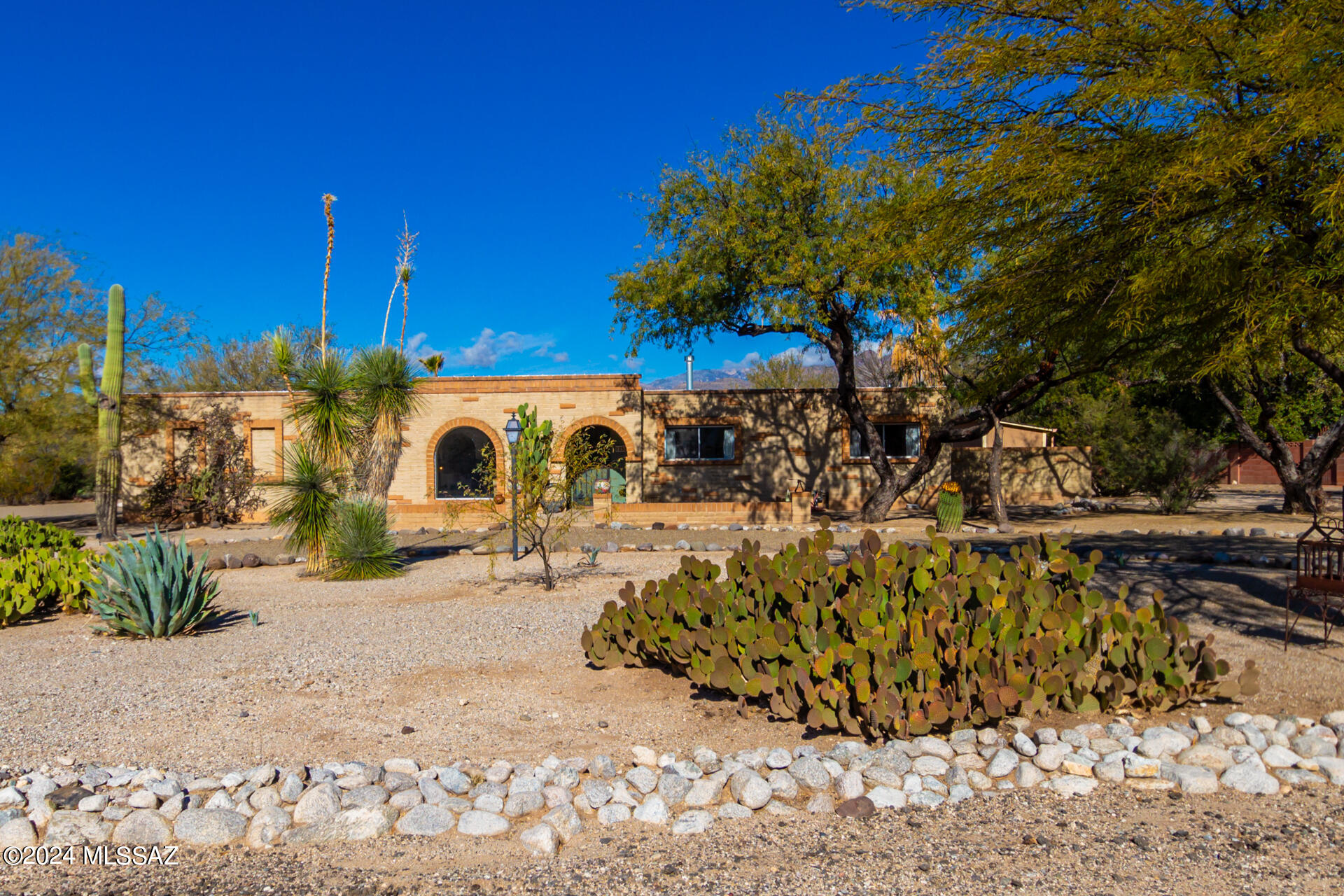 One of a kind 4-bed property on a corner lot on a cul-de-sac! East side location. Minutes walking distance to Tanque Verde Elementary School and Forty Niner Country Club. Masonry construction. Sellers' VA loan (4.625%) may be assumable. Breathtaking mountain views.  Premium .85 acre lot. Space for RV. Circular driveway, mature landscaping, courtyard, 2-car garage. Bright, open interior. Functional & flowing. Wood burning fireplace. New wood-plank tile floors. 2 living areas. Formal dining room. Ideal home for entertaining. Gourmet kitchen. Fully equipped w/ wall ovens, granite counters, & walk-in pantry. High end wood cabinetry. Main suite features a walk-in closet & outdoor access.  Backyard oasis w/ pool and covered patio. Outdoor living at its best. Storage shed. Workshop. The expansive backyard will not disappoint with its covered patio set on pavers & a refreshing pool ready to enjoy. Make this gem yours now!