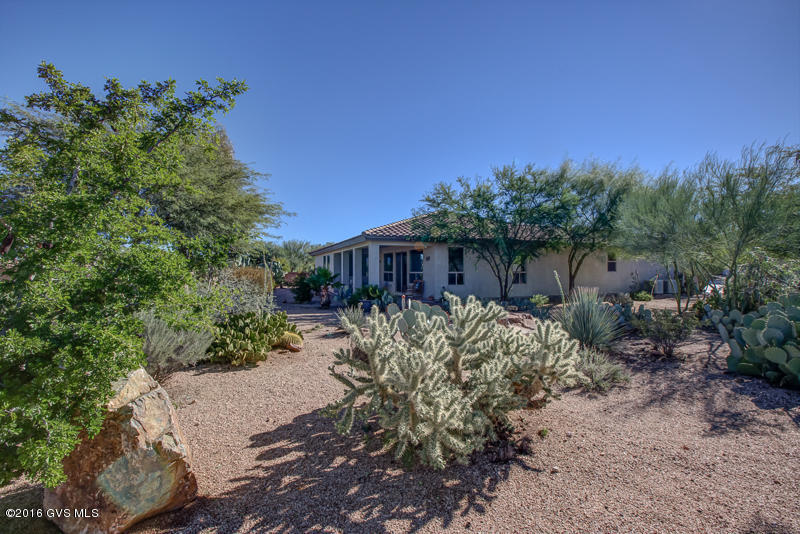 Popular Cimarron model. Offer's large open great room. Very large private lot that backs up to a large natural arroyo. You will have mountain views, and Green Valley lights at night. This can all be seen from the large windows in the great room/dining area and of course the covered back patio that faces north. Home has been gently used and is ready for new owner's to put their personal touch on it. Master has the largest closet that you have ever seen. Kitchen has engineered stone counters, GE profile appliances, lots of cabinets with pull outs. Easy care flooring thru out the house. No carpet anywhere. Garage has been extended. Priced well. You don't want to miss seeing this home. It could be yours today!
