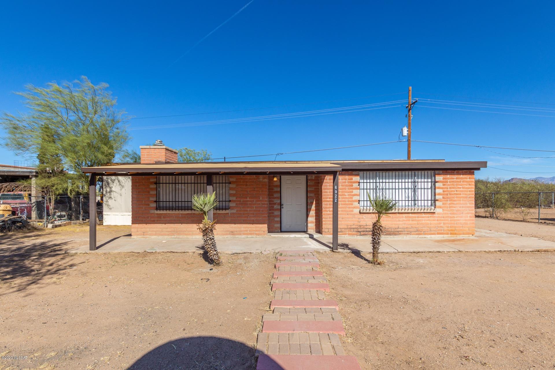 Beautifully Remodeled Home w/a gated entry, charming brick fireplace, beautiful tile floors, fresh palette, window blinds, & step up into dining area. New AC, windows, roof all installed in 2020. Handsome engineered wood floors in all the right places, stylish kitchen counters, glass tile backsplash, SS appliances, & plenty of wood cabinets. The dining area is perfect for dinner entertaining.  2 Updated bathrooms w/designer tile, mirror, new vanity, fixtures, & 1 bath w/a granite counter.  Ample closets, spacious bedrooms, & interior laundry closet. Extended covered backyard area, storage shed, & plenty of space for your toys, RV or garden!  NO HOA!  Come see today!