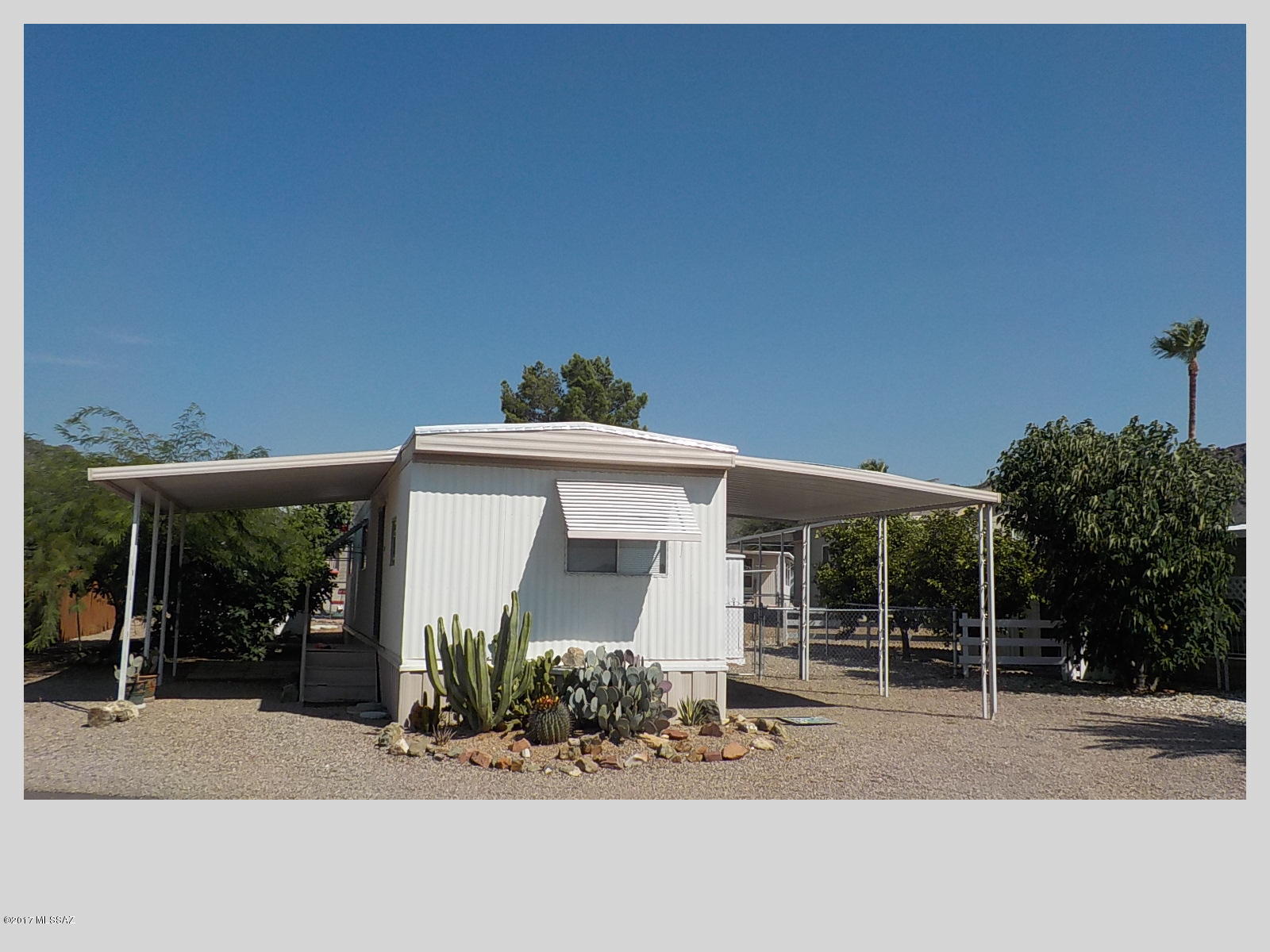 55+ community nestled at the bottom of Tucson Mountains. The home would work great for a winter home, year around living or rental. Living off kitchen and dining. Light and airy. Fenced side yard. Washer and dryer in outside bldg. FURNISHED----New furnace.