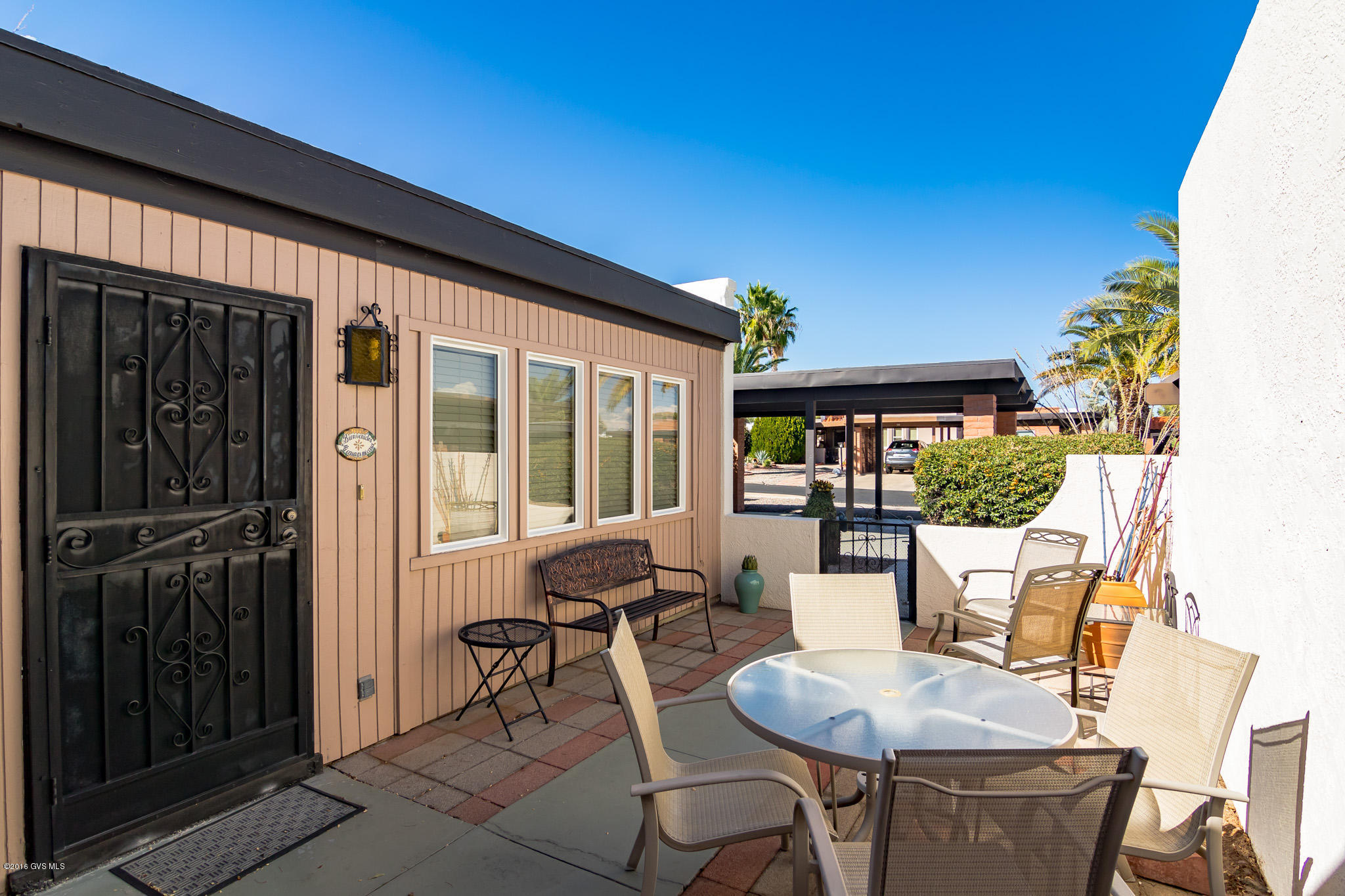 Cute as a bug's ear, this special corner lot home has many updates. One step inside the courtyard & you'll be wanting more. The interior does not disappoint with an updated kitchen that has custom cabinets, newer appliances and a skylight that lets the light stream in. You'll be surprised at just how big 1,102 sq. ft. feels in a well designed floor plan. The living/dining area flows seamlessly into the kitchen & AZ room. There is a fireplace in the living room that will take the chill off a cold winter's evening. Arizona room is not permitted & hasn't been included in the square footage--giving you bonus living area! The large slider in the AZ room leads to the large patio in back. Fully furnished as shown. A MUST see...this one won't last long.