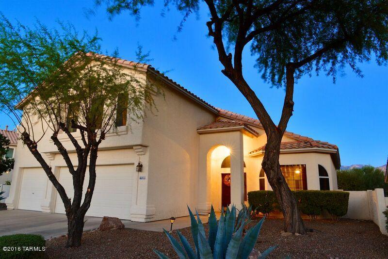 Views, views and more views! this 4 bedroom home with den backs to a beautiful desert green belt. Beyond that you can see the Catalina Mountains! New area park complete with trails and archery nearby. This home has all the bells and whistles - big family room off kitchen with Fireplace. Living room and dining room with high vaulted ceilings. Abundant kitchen cabinets, pantry and SS appliances. Beautiful silestone counters and tile floors. Master suite offers the very special feature of a balcony. Enjoy the magical mtn. views and city lights from this vantage point. Over-sized shower, newer tile & cabinets. Den off master can be used for an office, exercise room or even a nursery. Must have - 3 car garage and more!