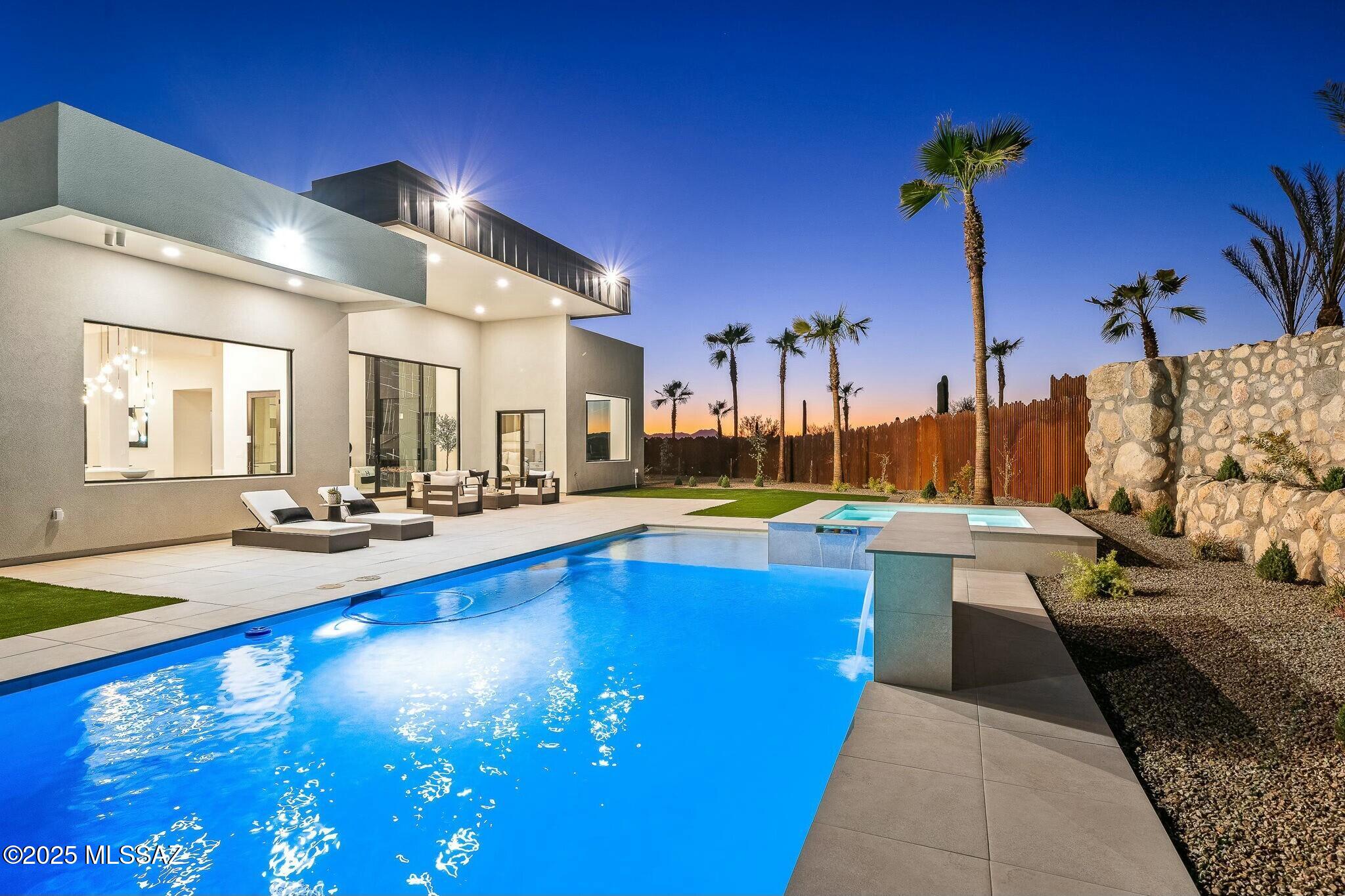 NEW CONSTRUCTION! Nestled on a sprawling 3.76-acre lot in the heart of the Catalina Foothills, this expansive property encompasses over 8,000 sq ft, 10 bedrooms, 9.5 bathrooms, its own well, & its own private gate. Offering unparalleled luxury & space and built by master builder, Monty Bartholomew, of Real Exquisite Estates & Properties, who has built some of Tucson's most luxurious properties. The new construction main home spans 5,464 sq. ft., featuring 6 bedrooms, 5.5 bathrooms, & a 3-car garage with epoxied floors. Every detail speaks of elegance including the great room which features a 12 ft tall multi-slide glass door that reveals panoramic views of the Catalina Mountains. The chef's kitchen is a masterpiece boasting custom cabinetry by Affinity Kitchens, high-end appliances including a 6-burner gas range with double ovens, & granite and quartz countertops . Enjoy meals in the dedicated dining room, complete with a convenient wine refrigerator & ample built-in storage. Throughout the home, 24"x48" porcelain tile flooring exudes sophistication. The master bathroom is a sanctuary, designed with spa-like features including white oak cabinetry, Taj Mahal quartzite countertops, a gorgeous glass shower, & separate vanities. The main home offers 5 additional spacious bedrooms, all (with the exception of one) include their own en-suite bathrooms, providing ultimate privacy.

The detached guest house was built in 1956 and was completely renovated in 2019. The guest home consists of 2,541 sq. ft., complete with 4 bedrooms, 4 full bathrooms, and is ideal for multigenerational living or potential short-term rental income. The property also has no HOA and allows for horses, the options are truly limitless in the one-of-a-kind property!